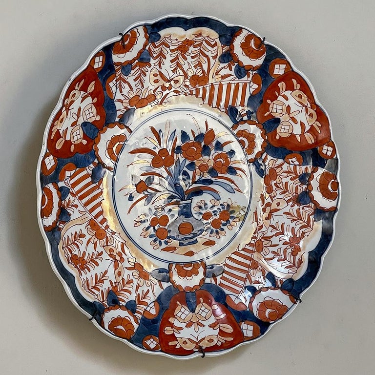 19th Century Imari hand-painted charger is a fine example of decorative porcelains from Kyushu in northwestern Japan. Imari is a style of porcelain named after the Japanese port from which it was shipped to the West, beginning in the late 17th