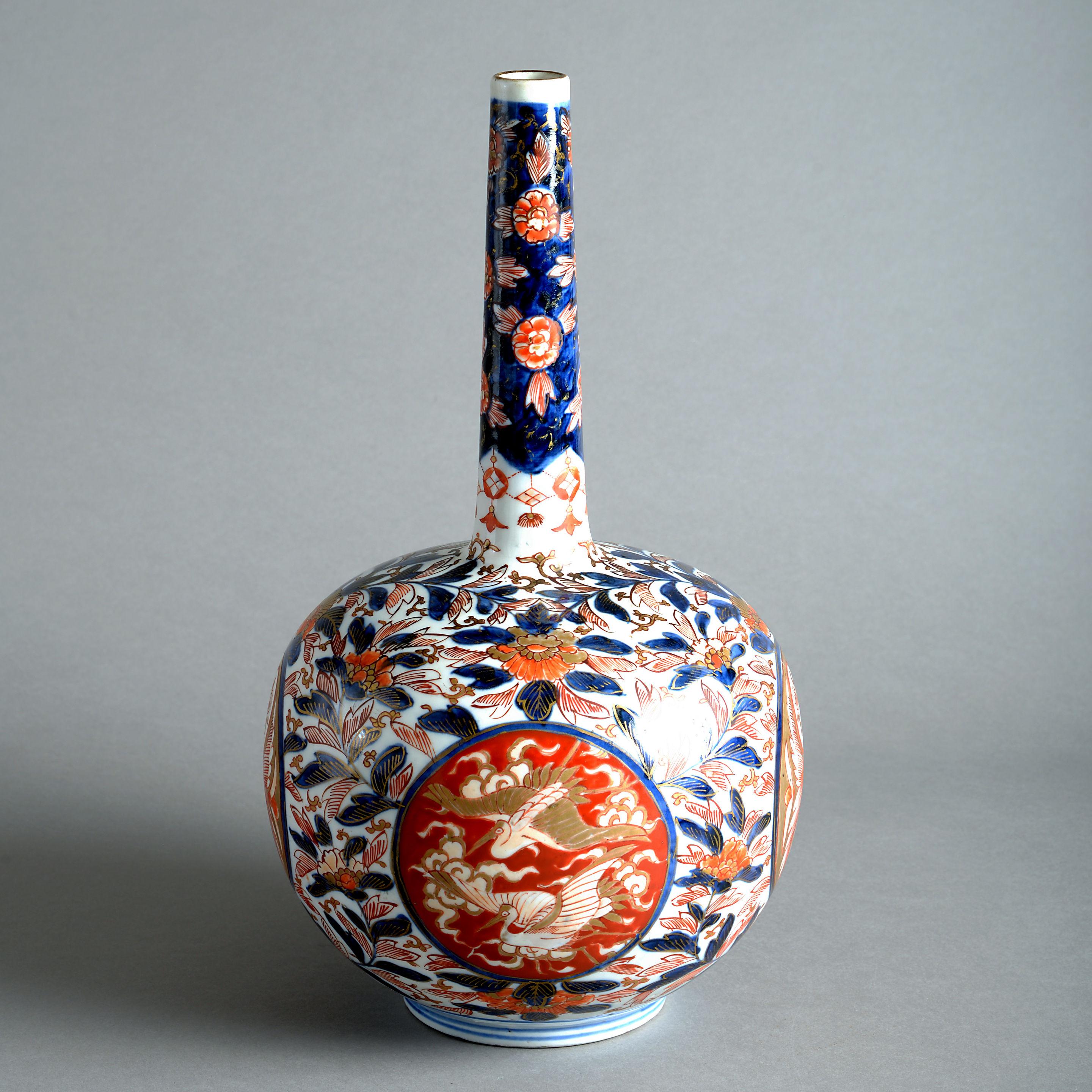 A fine late 19th century Imari porcelain bottle vase, decorated in the traditional manner with glazes in blue, red and gold upon a white ground.
  