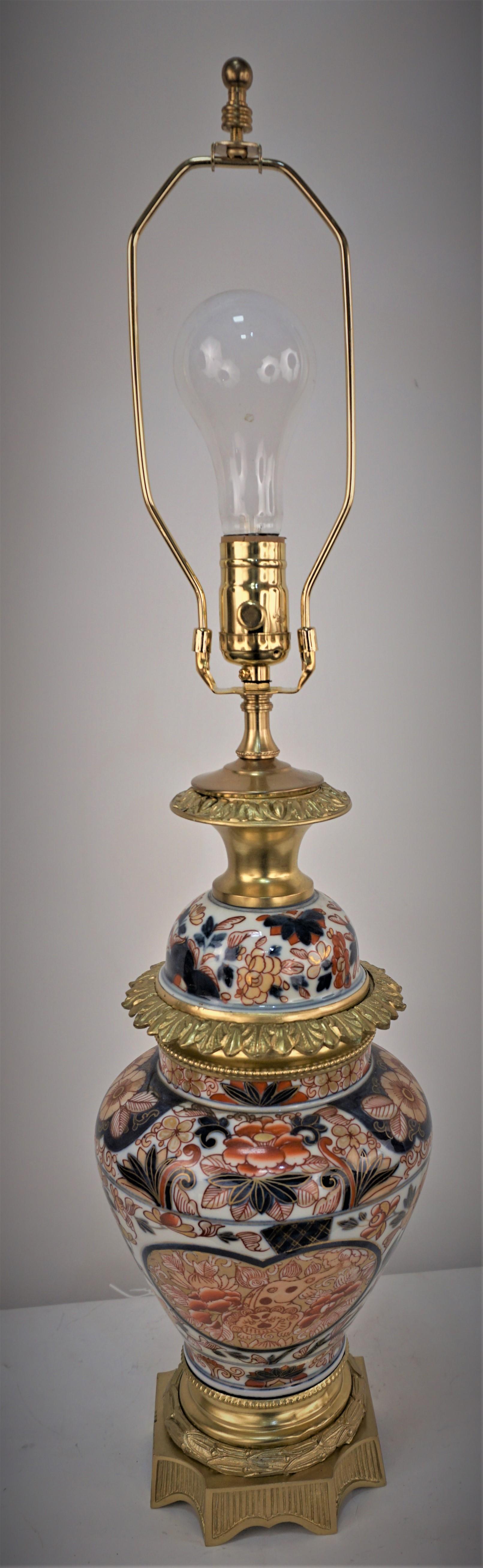 Imported 19th Japanese Imari porcelain lamp base to France and added bronze mounting to a beautiful oil lamp. and now professionally electrified and fitted with silk lampshade.
