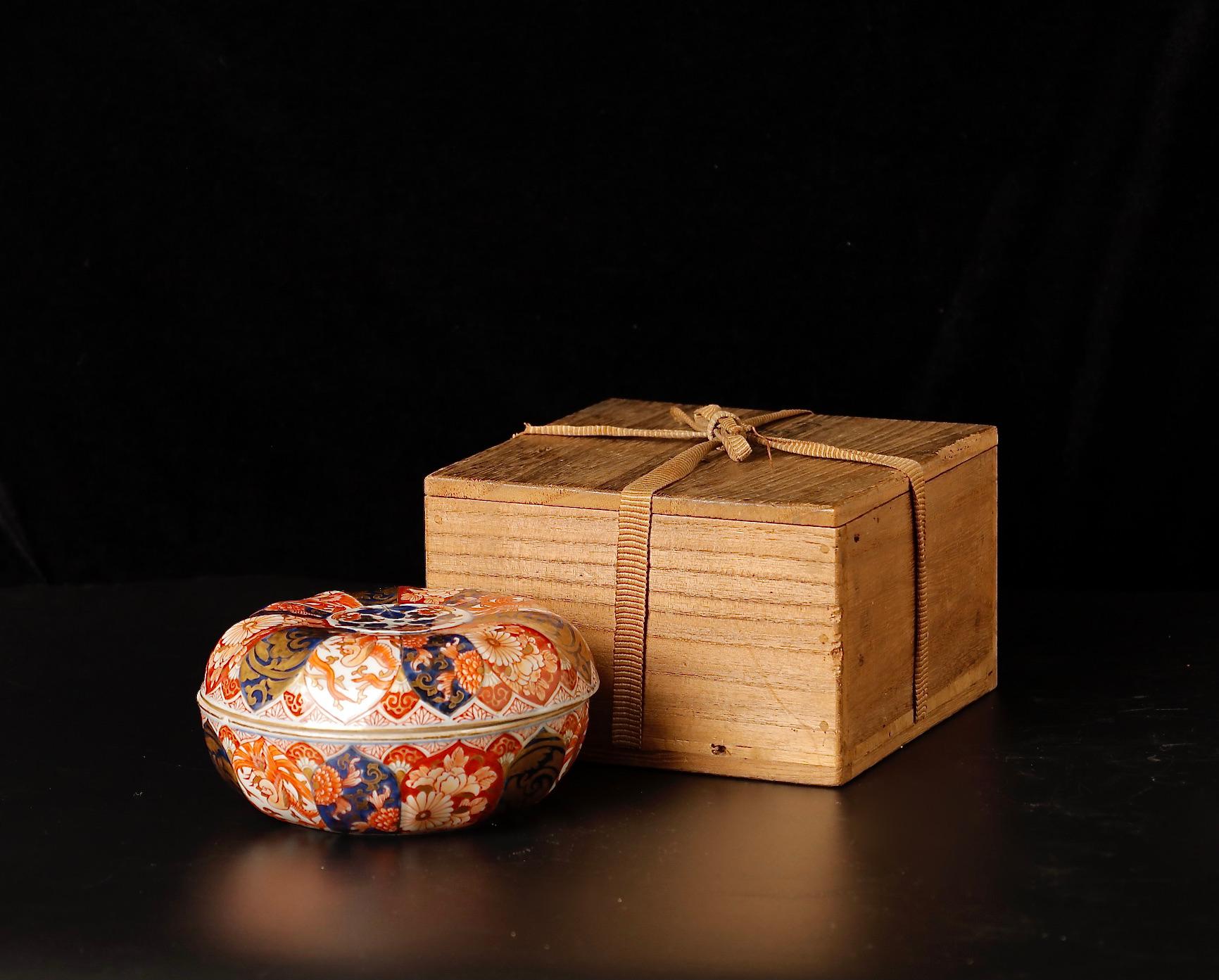 This 19th-century Imari ware box (SKU: ZD49) is a resplendent example of the cherished Japanese porcelain art form, renowned for its rich palette and intricate designs. Hand-painted with meticulous care, the box displays a kaleidoscope of