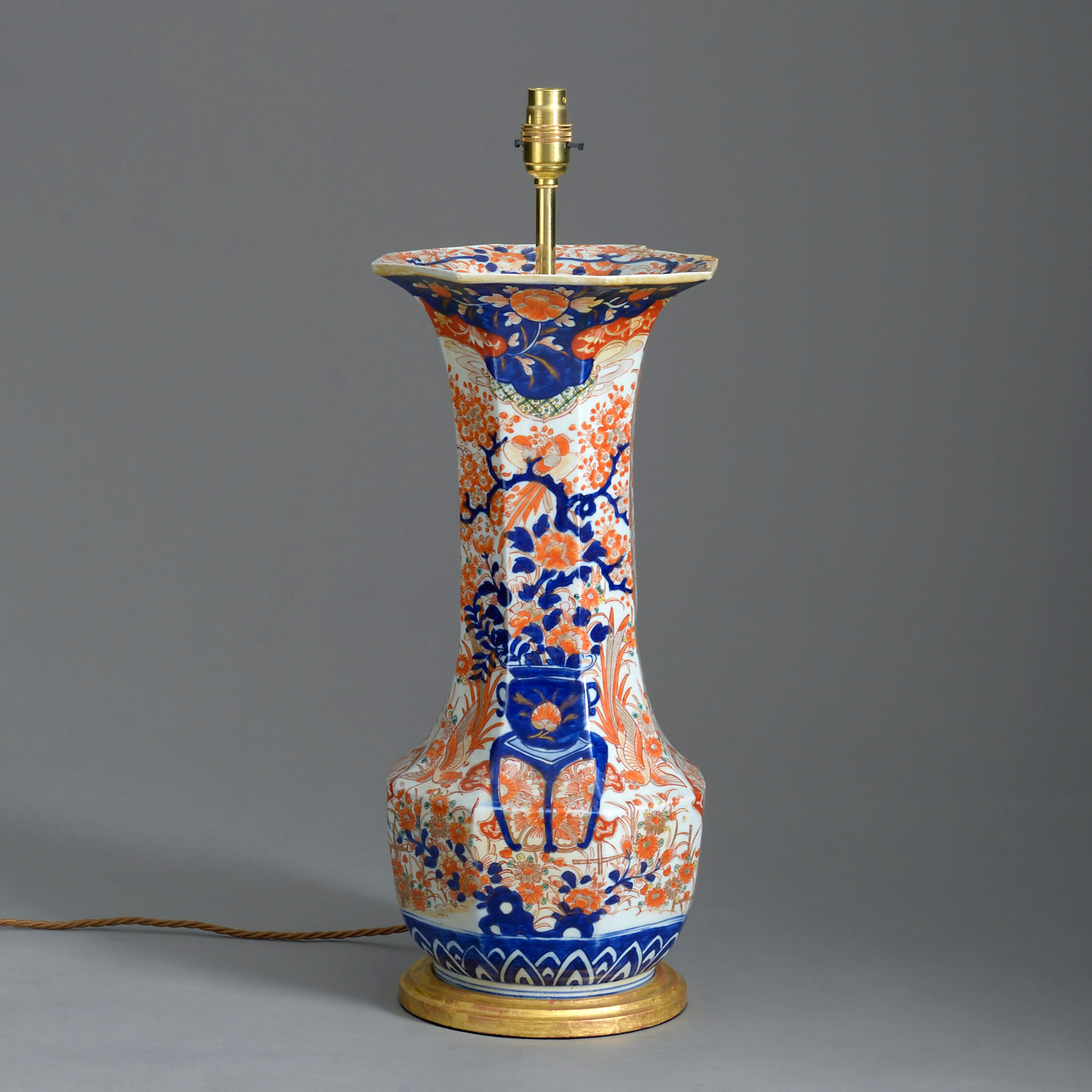 A late 19th century Imari porcelain trumpet vase, decorated throughout with red, blue, green, and gold glazes upon a white ground in the traditional manner. Now mounted as a table lamp.

Height dimensions refer to height of vase only.

Wired and