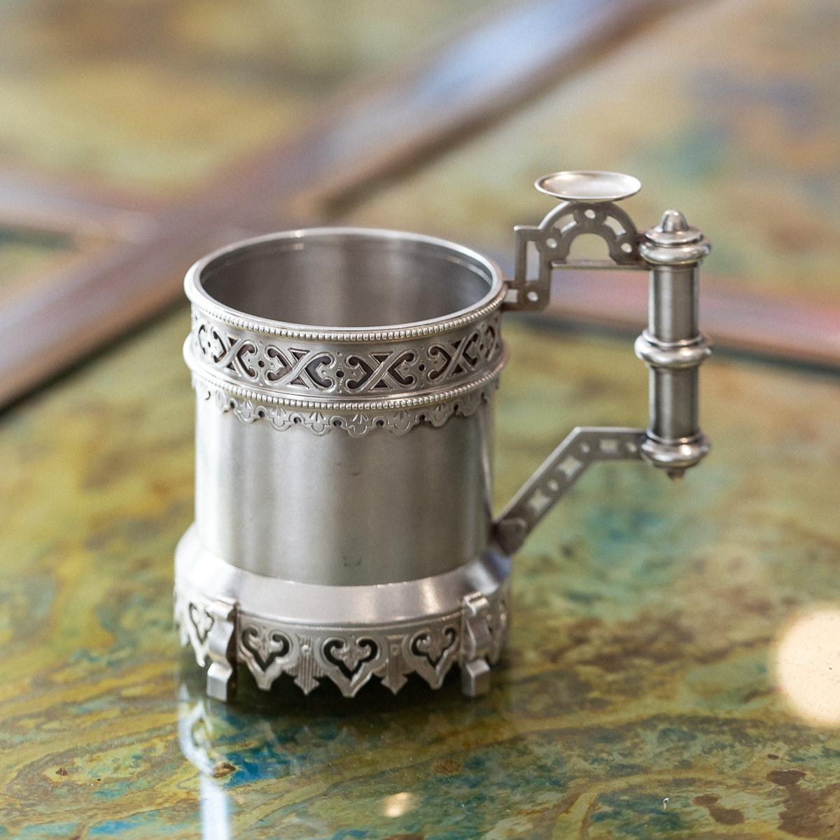 Antique 19th Century Imperial Russian solid silver tea glass holder of a cylindrical form, beautifully applied with pierced and engraved boarders, on shaped supporting feet and applied handle also in cylindrical form with added thumb piece adorning