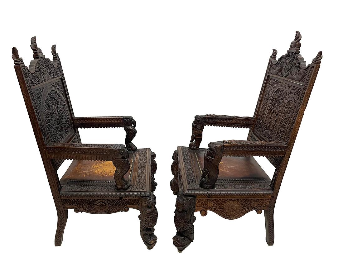 19th Century Indian armchairs

19th Century Indian set of two armchairs, richly hand-carved. The coconut wooden chairs have beautiful scenes of Buddhist Gods, animals and floral decor. On top of the chairs figures of Sadhu, The backrest with floral