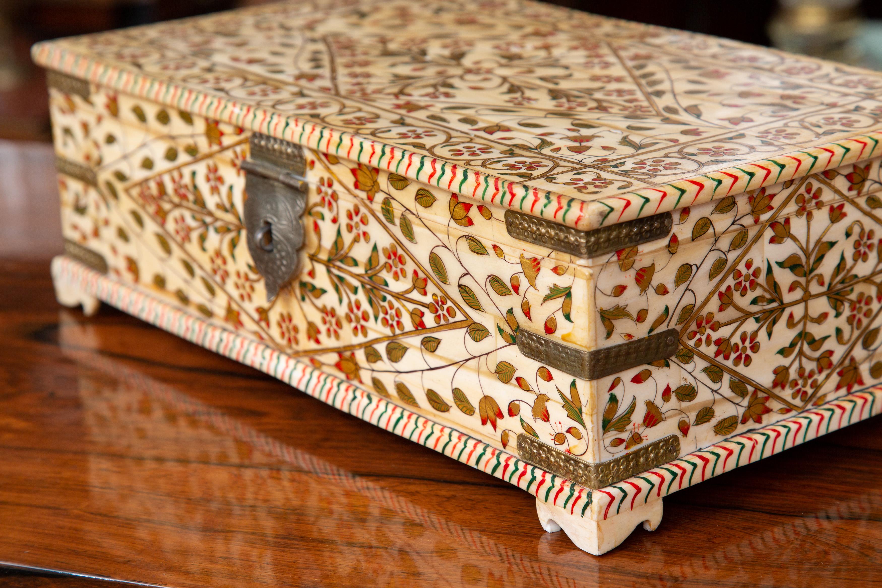 This is an Indian bone-veneered lidded box, painted over-all with colorful flowers and foliage.