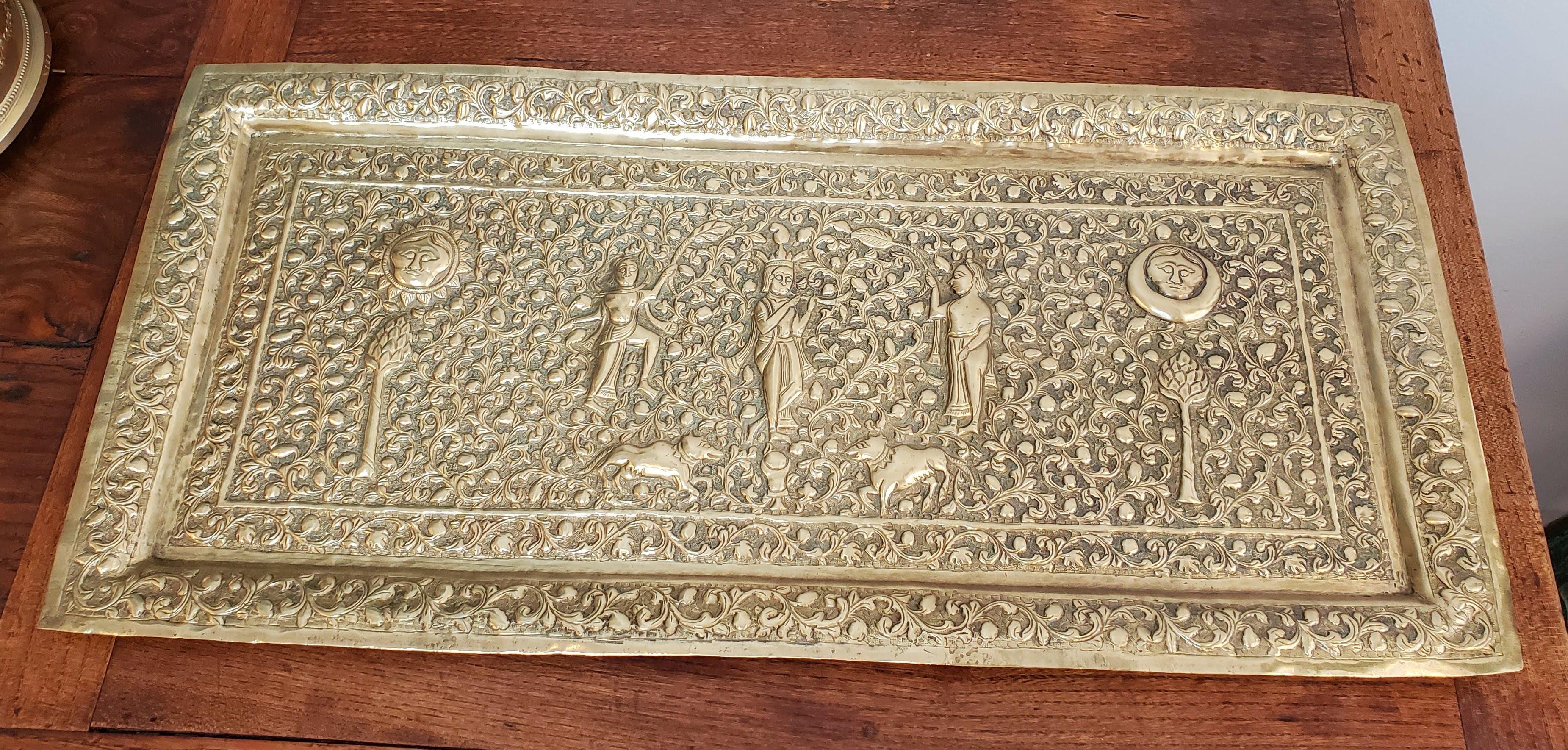 19th century Indian brass platter. Heavily embossed floral decoration, human figures, animals and Hindu deities. Unusual proportions. 
India, circa 1850.
Measures: 11.5” H 24” W 0.5” D.