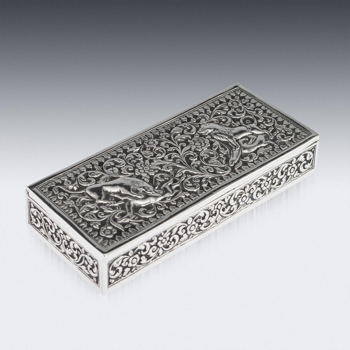 Antique late 19th century Indian Kutch (Cutch) solid silver stamp box, of octagonal form, impressively heavy gauge and exceptionally fine workmanship, the lid depicting a lion and a lioness killing an antelope, surrounded by foliate and floral