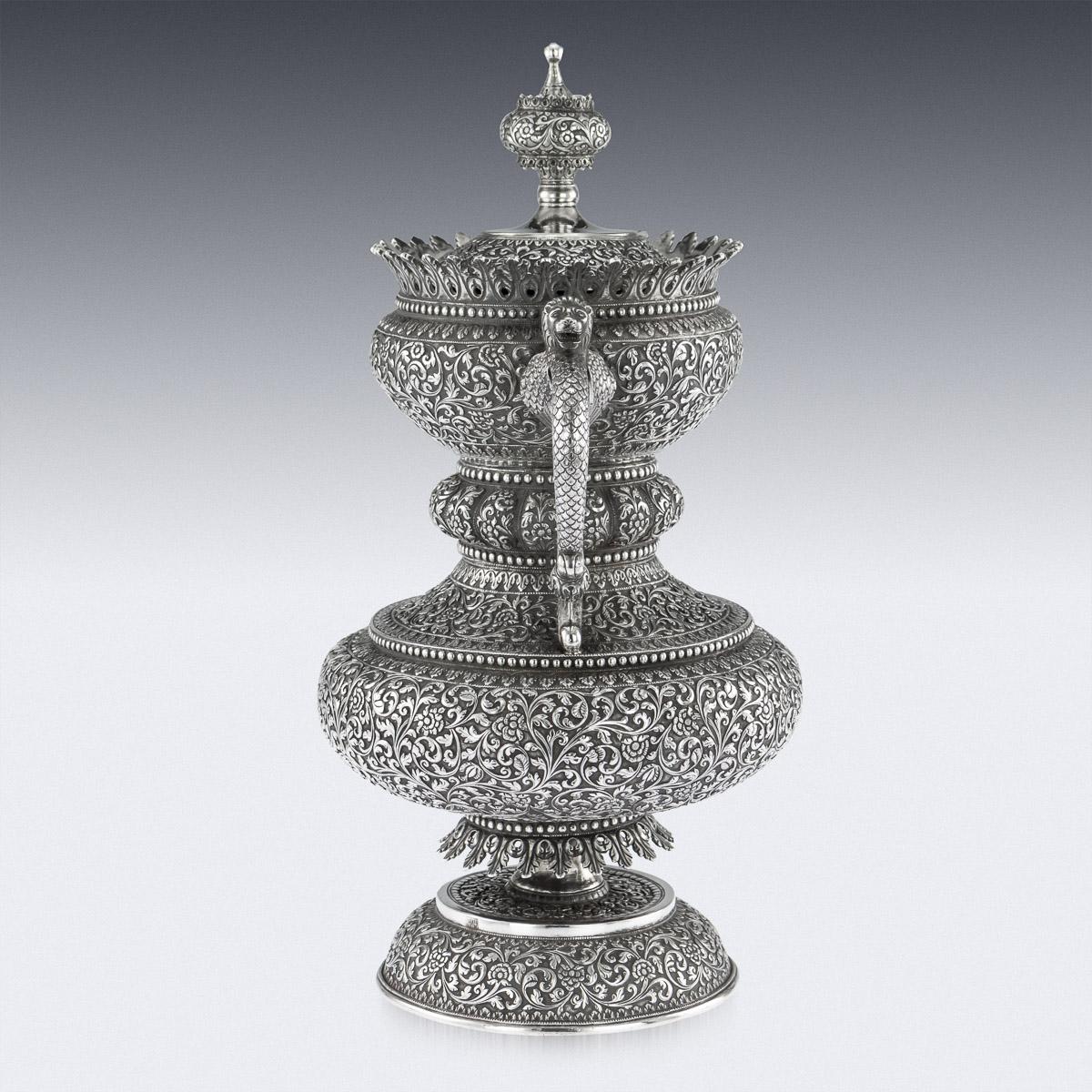 Antique 19th century Indian Colonial solid silver Cutch presentation cup with cover, unusually shaped body resting on a circular domed foot, the sides applied with a scroll handles terminating with mythological winged lions, possibly the depiction