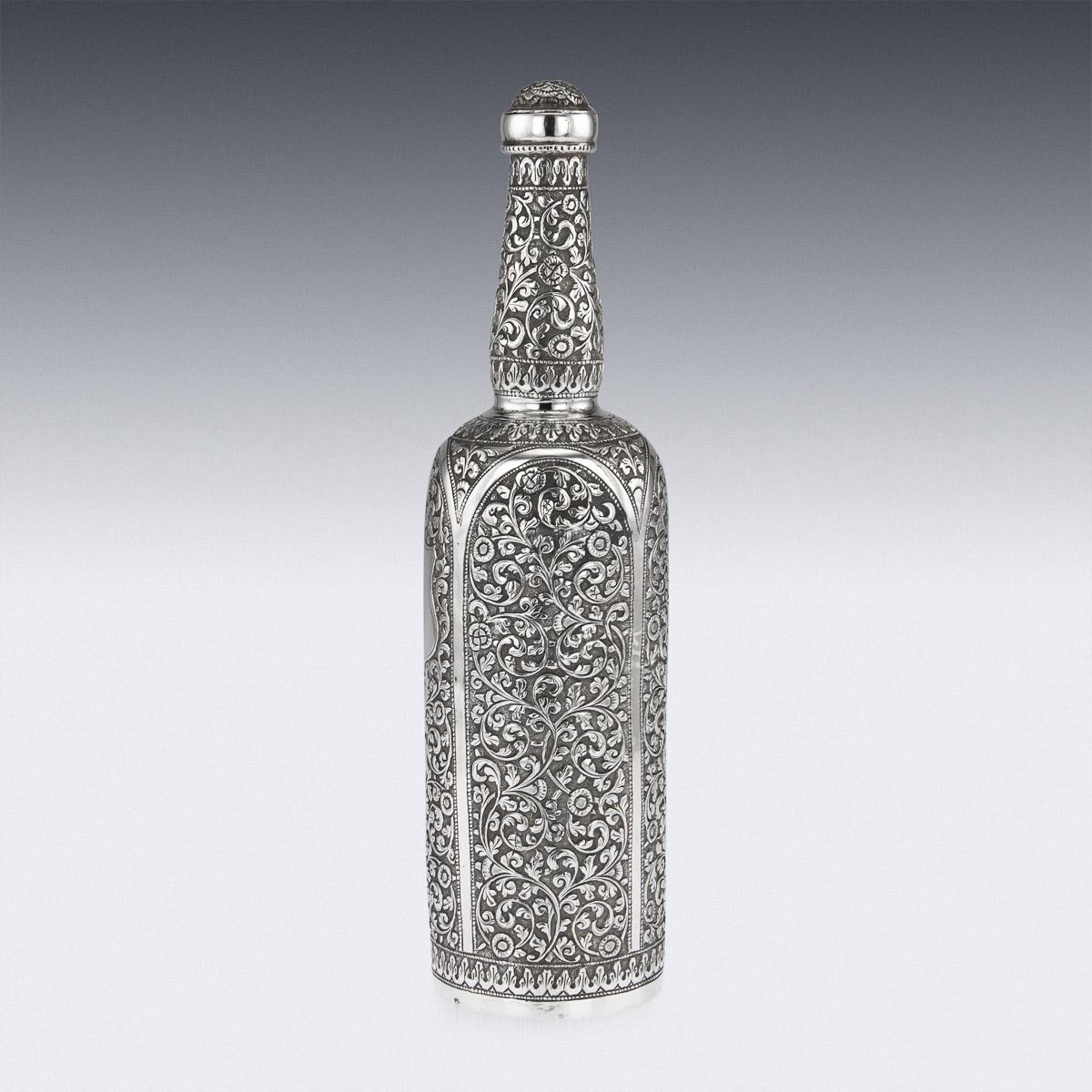 Antique late 19th century Indian Kutch (Cutch), Bhuj, Gujarat region handcrafted solid silver wine bottle with removable stopper. Of heavy gauge, decorated all over with typically Cutch chasing, distinguished by its closely worked, foliate and