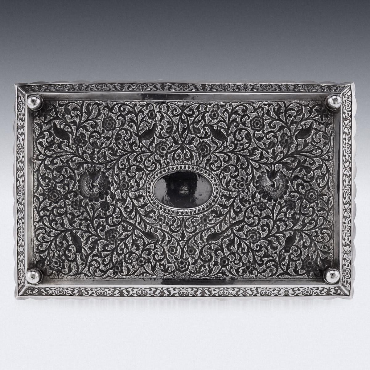 19th Century Indian Kutch (Cutch), Bhuj, (Gujarat region) hand-crafted solid silver tray, of shaped rectangular form, finely chased throughout with scrolling leaves and floral patterns on a finely tooled matted ground, the tray resting on four ball