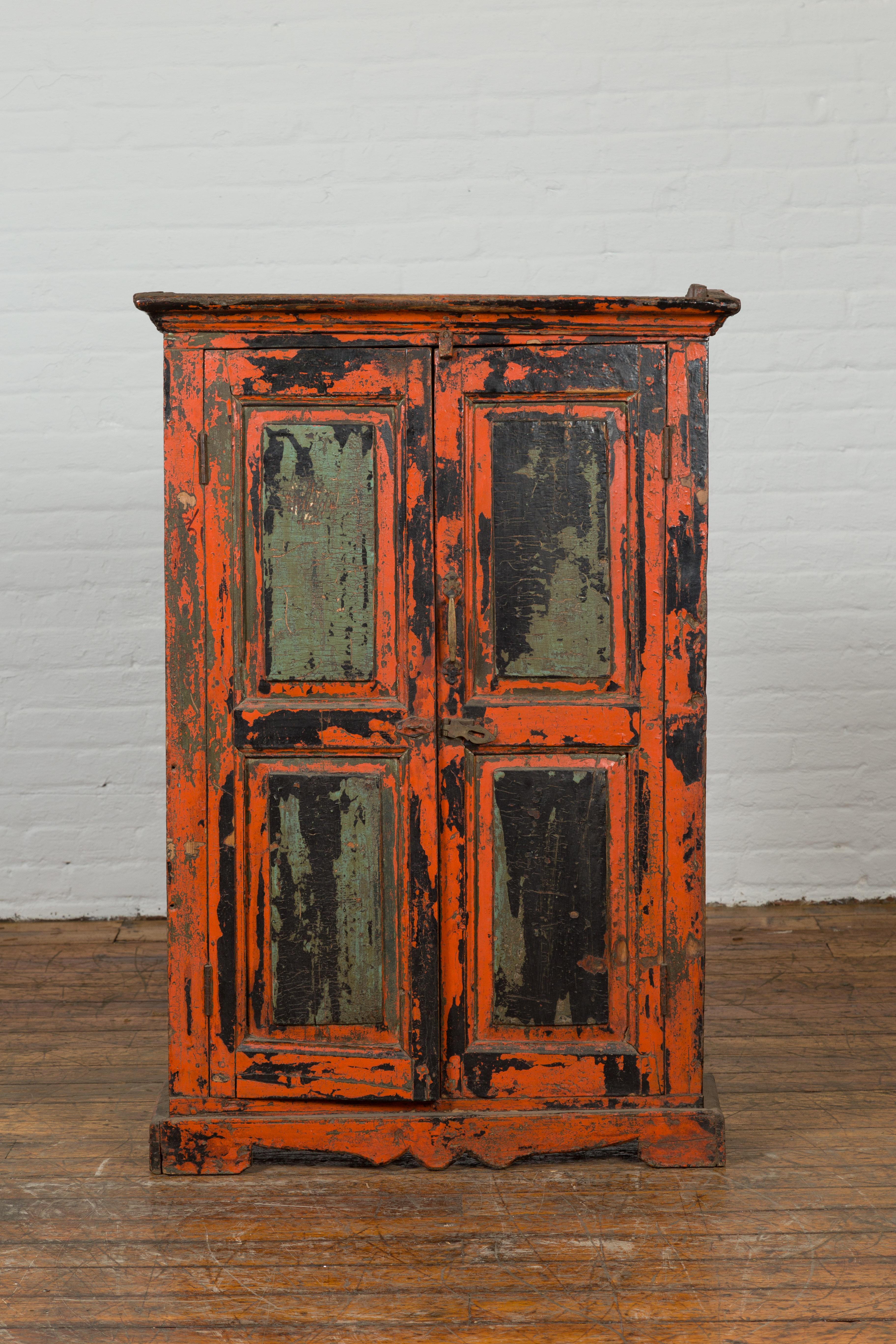 A stunning antique hand-painted cabinet with a beautiful distressed patina that makes this a unique addition to our vast antique cabinets collection. Created in India during the 19th century, our large antique cabinet features a long rectangular top