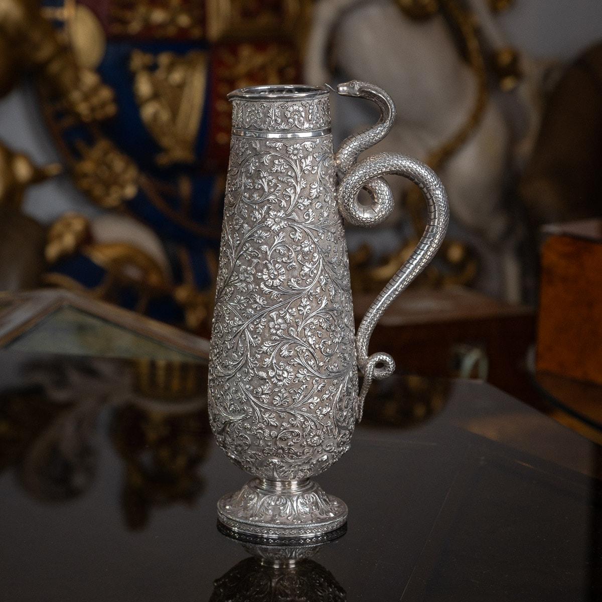 Antique 19th Century Indian (Kutch, Bhuj region) solid silver repousse' water jug / ewer, of magnificent quality, extremely heavy, the tall tapering body resting on a domed spreading foot, fantastically chased with scrolling leaves and flowers and