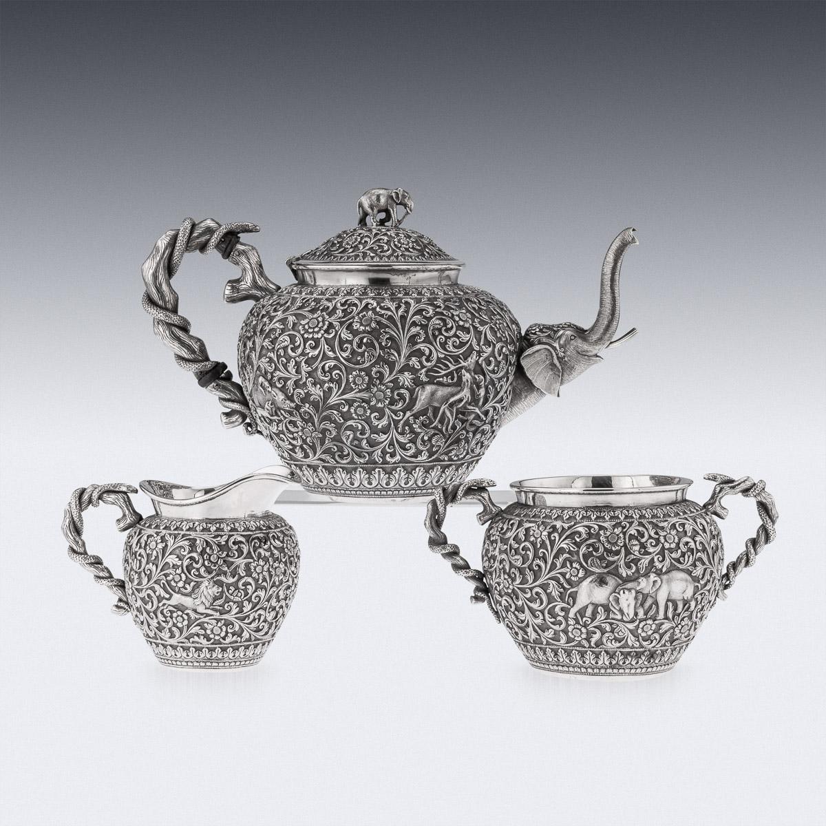 19th Century Indian (Kutch) silver three-piece tea set on tray, comprising of a teapot, sugar bowl, cream jug and tray, each piece is profusely and beautifully repousse' decorated with scrolling foliage and flowers on a tooled ground, depicting