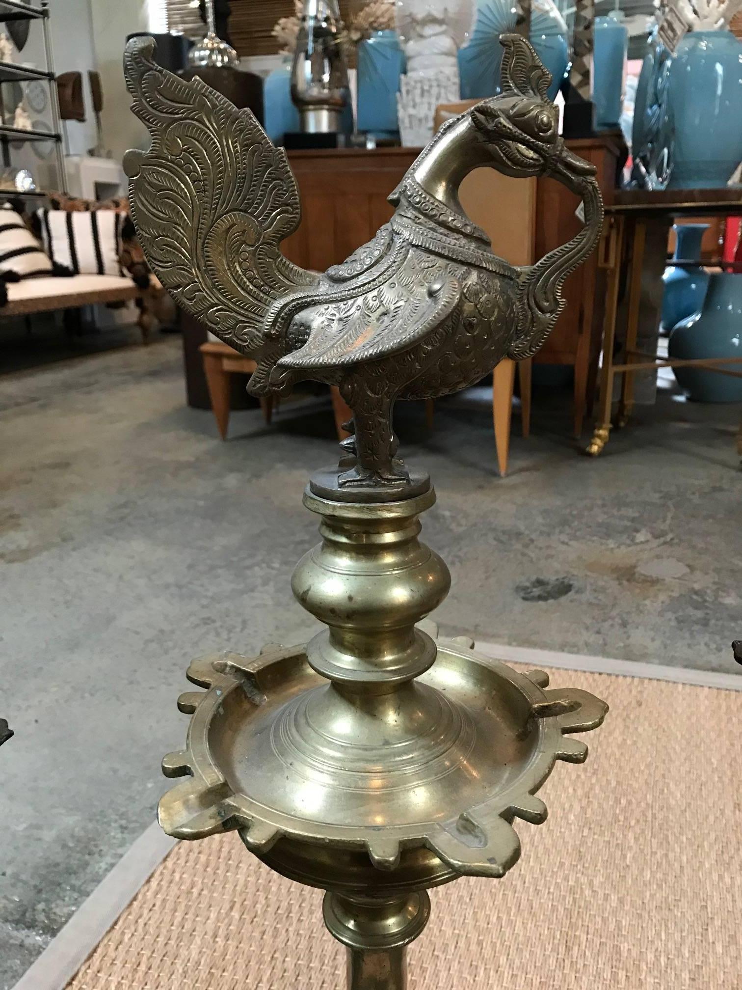 Three different tall oil lamps with rooster with varying aging and minor details.