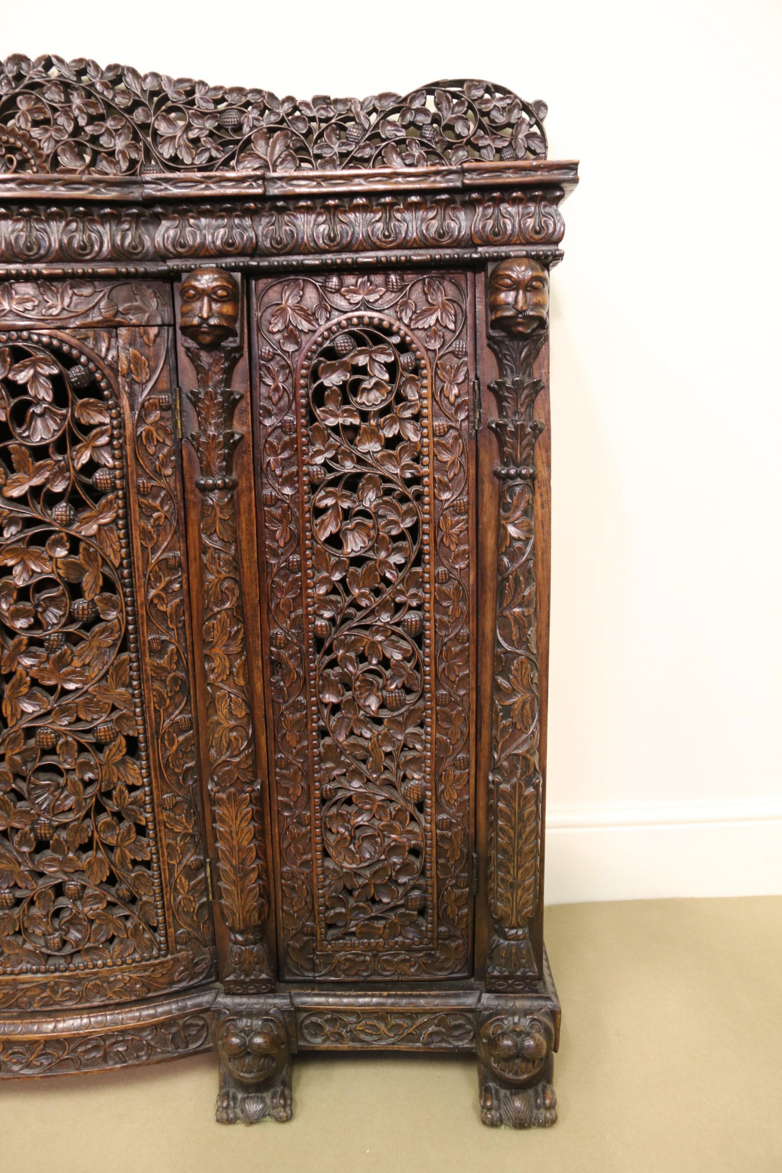 Anglo-Indian 19th Century Indian Ornately Carved Padauk Wood Four-Door Side Cabinet For Sale
