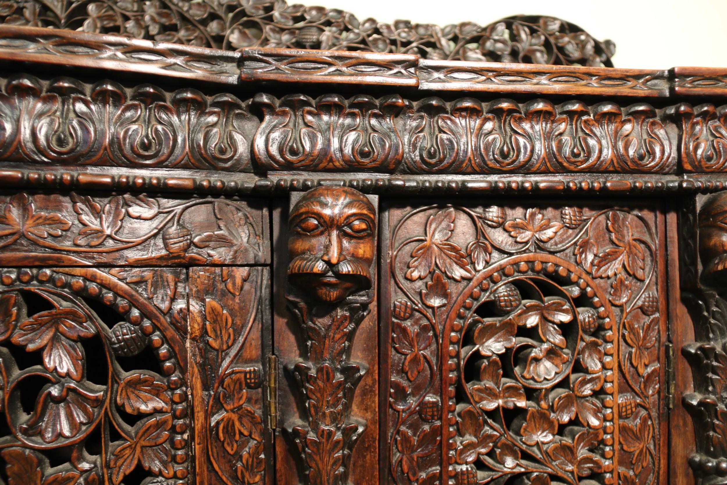 Hardwood 19th Century Indian Ornately Carved Padauk Wood Four-Door Side Cabinet For Sale
