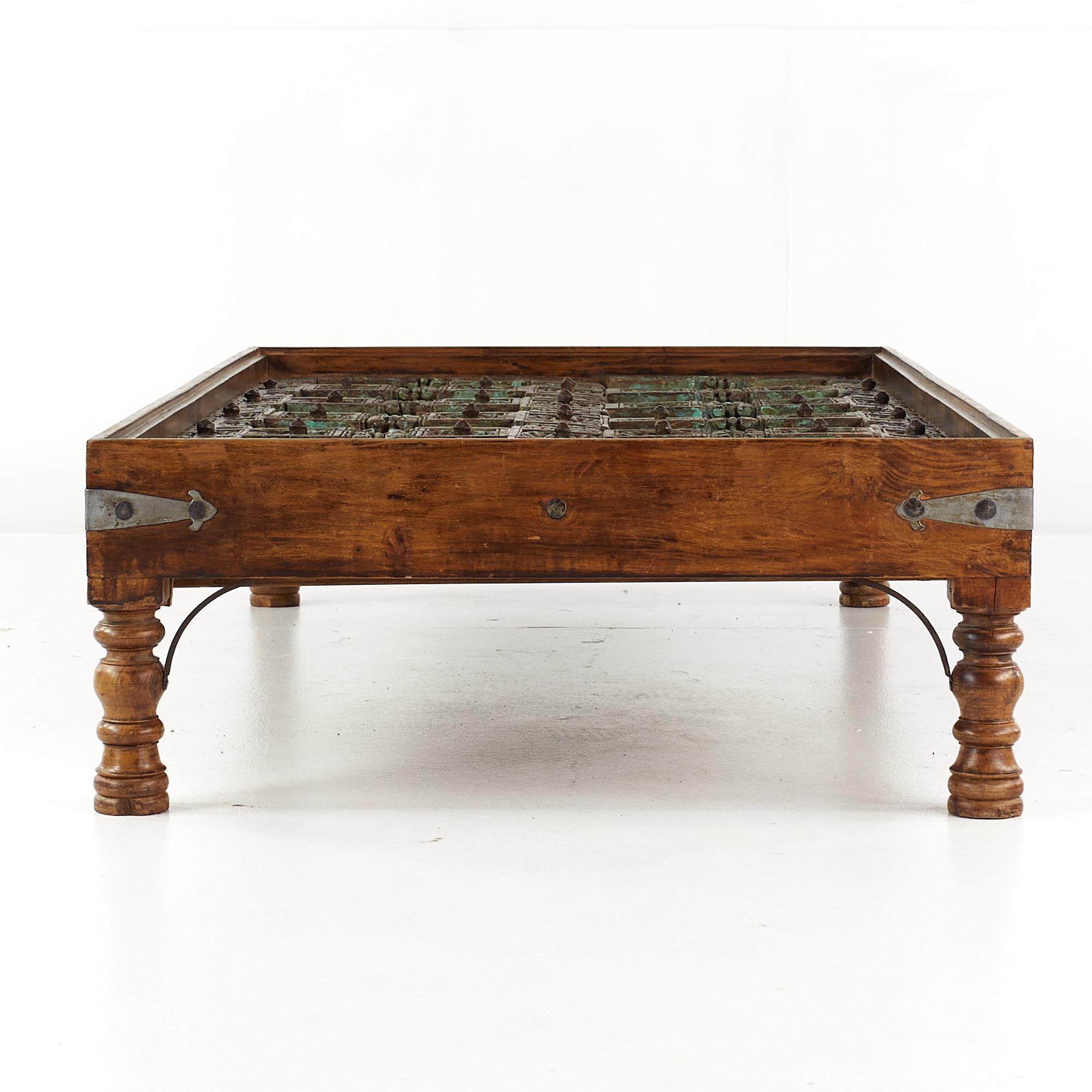 Glass 19th Century Indian Paneled Door with Iron Accents Converted to a Coffee Table