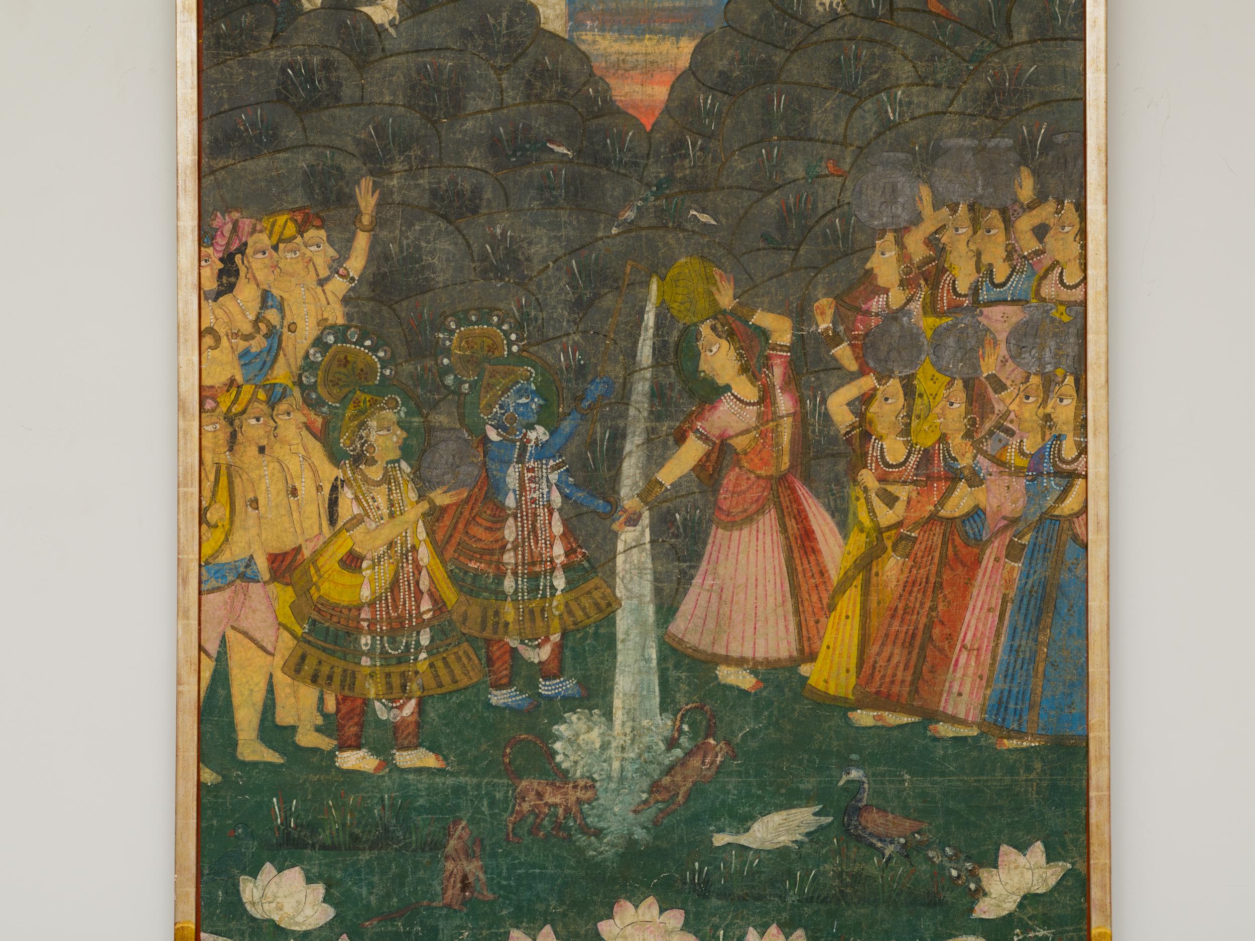 Beautiful 19th century Pichhwai silk painting of Krishna and Radha accompanied by gopis, devas, 
the sun God Surya, plants and animals enjoying Dana Lila together.
Exquisitely painted on silk, framed in silver and gold c. 1980's gilt wood frame,