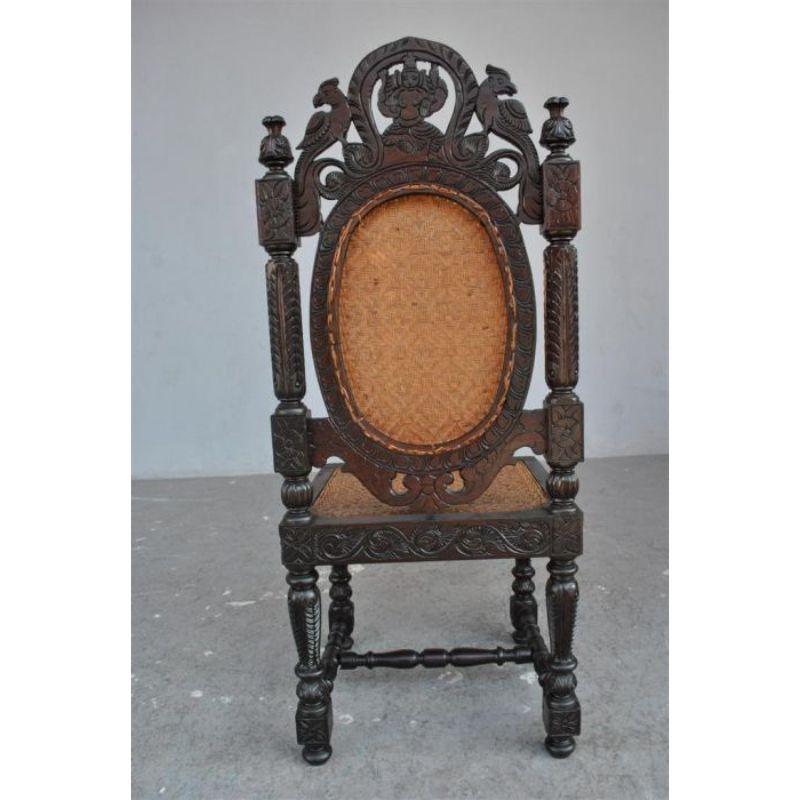 19th century solid Indian rosewood chair from a set imported into France at the very beginning of the 20th century from Bombay. Very richly carved and openwork with a motif of deities and animals. Dimension height 112 cm for a width of 46 cm and a