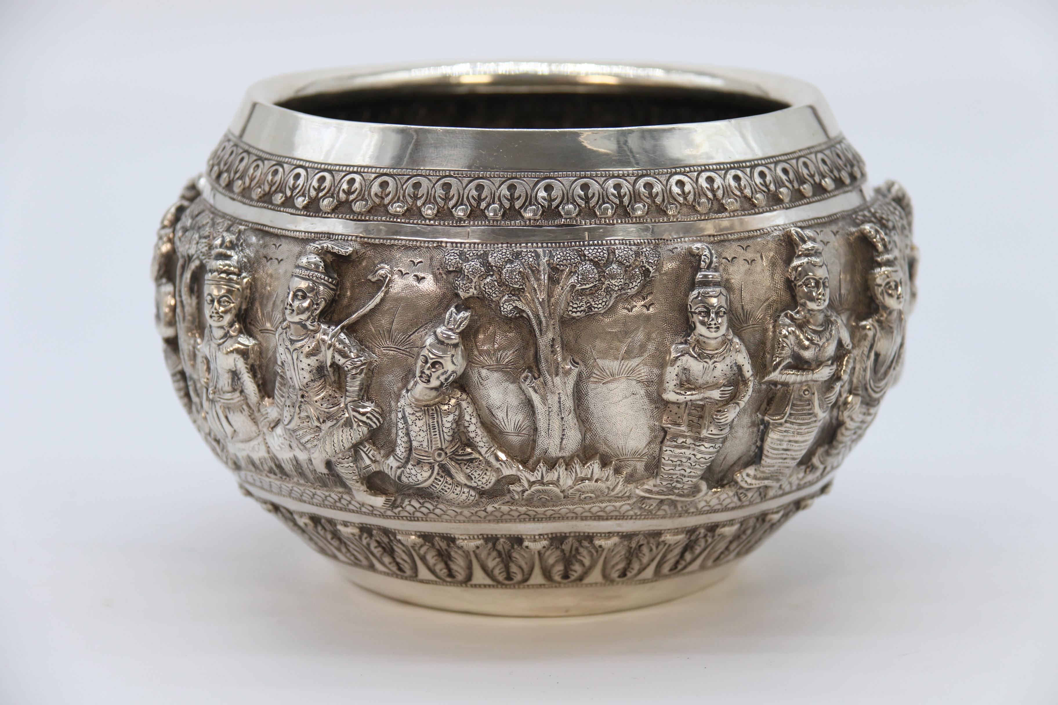 
This very high quality piece of impressive Raj period Indian silver is superbly decorated with three dimensional deep relief repousse work in the form of traditional male and female figures carrying out various tasks and religious customs.

The