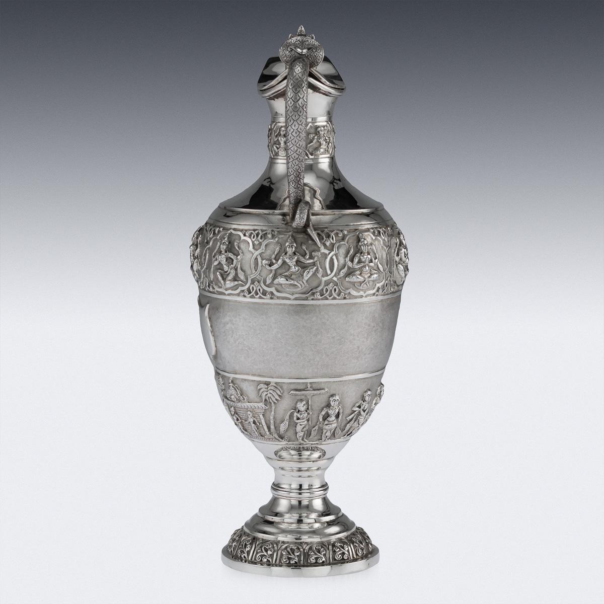 Antique late 19th century Indian Colonial solid silver repousse ewer, the top band is beautifully chased and repousse' decorated depicting Hindu gods and goddesses in elaborate cartooches, and the bottom band depicting religious processions on