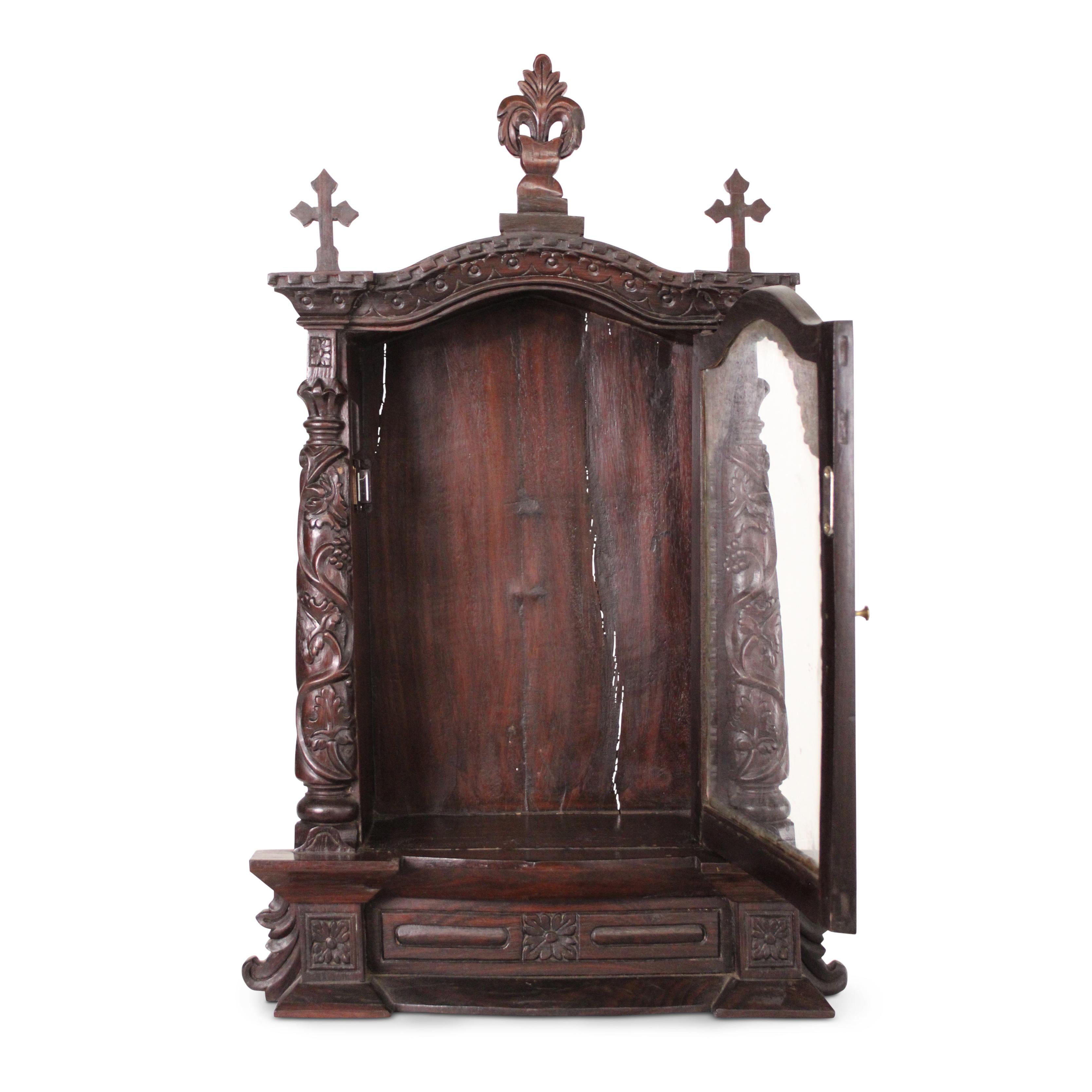 This 19th-century Indo-Portuguese altar was masterfully crafted from rich rosewood and crowned with a beautifully carved crosses at the top. This exceptional piece exemplifies the harmonious blend of European ecclesiastical design and Indian