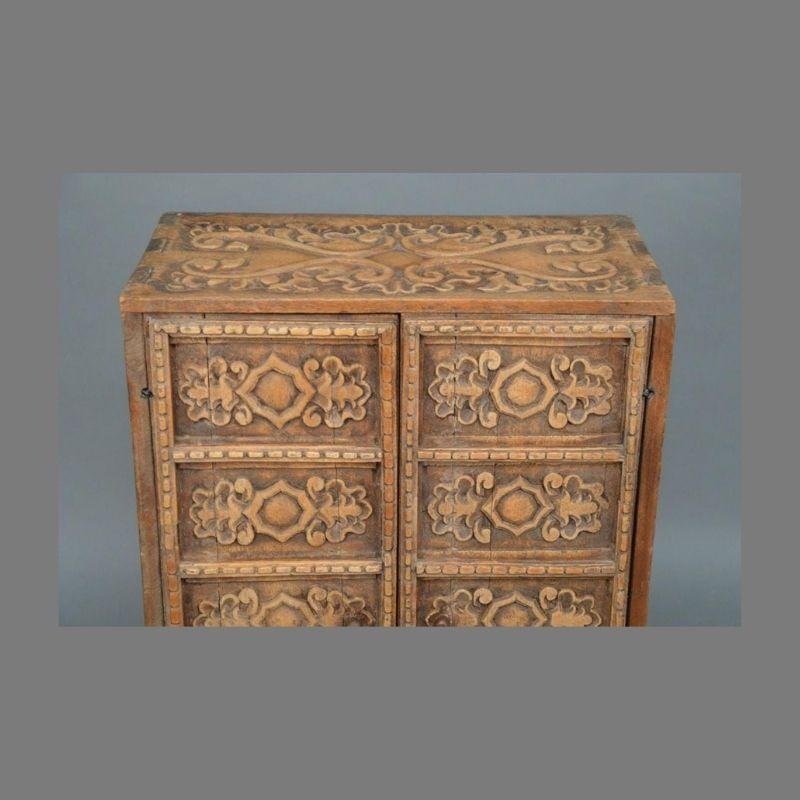 This extraordinary carved Indonesian two door cabinet will make a beautiful addition to your home. Made of teak with incredible relief carved decoration on all surfaces, it has wonderful small proportions which makes it a great fit for smaller