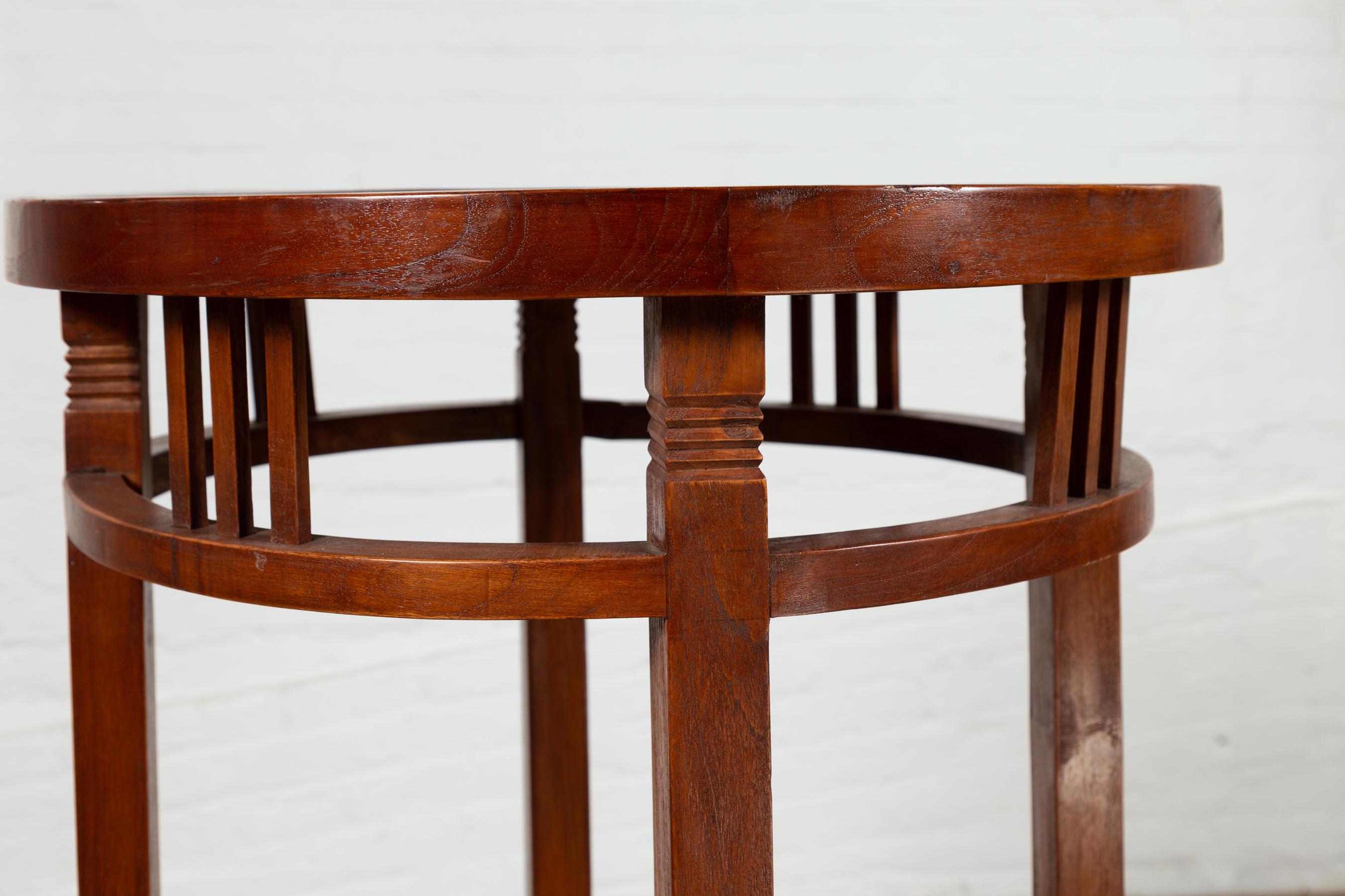 Wood 19th Century Indonesian Round Pedestal Table with Pierced Apron and Stretchers For Sale