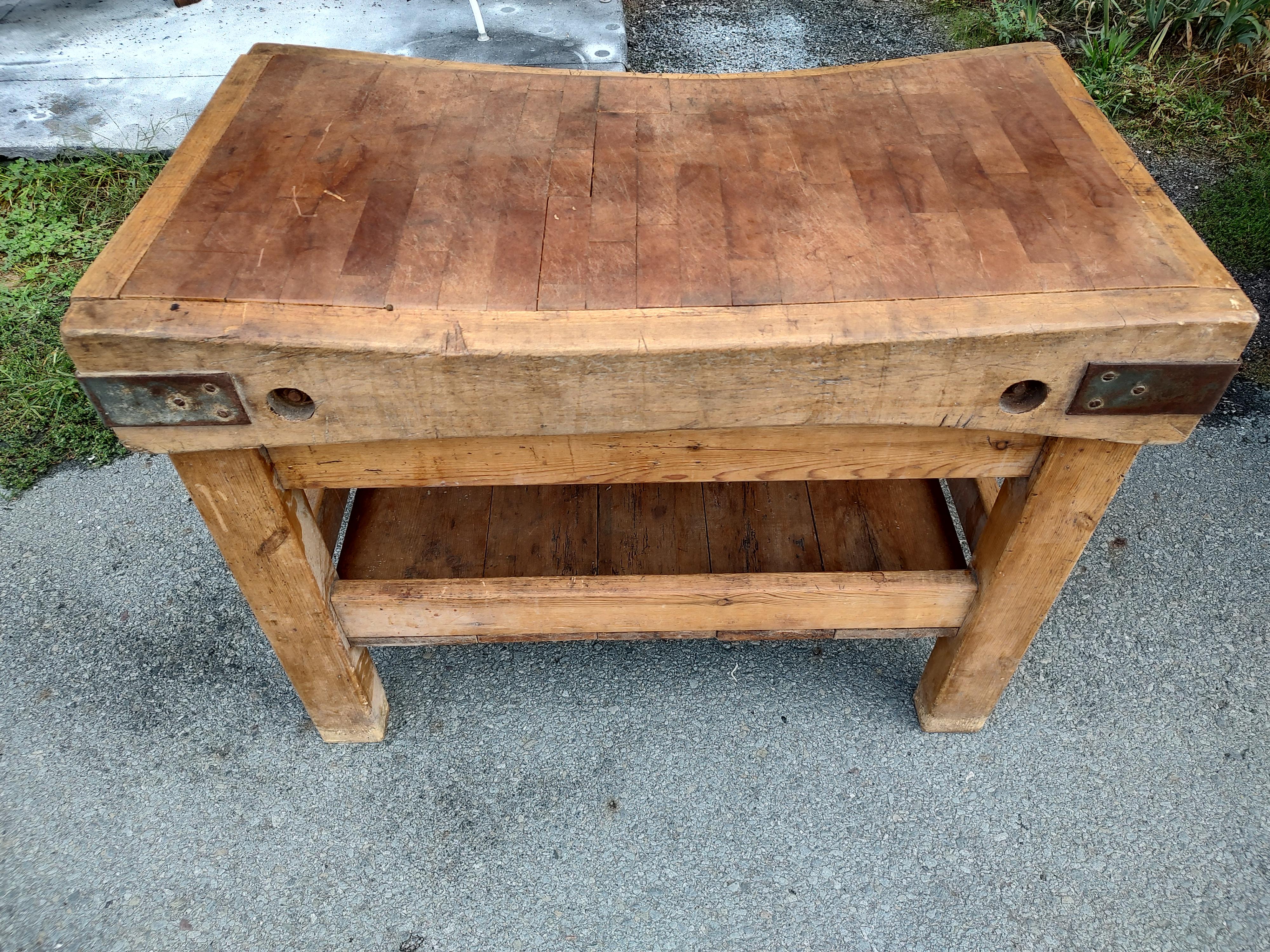 Fabulous and incredibly perfectly worn on both sides of the butcher block. 19th century and from England this hand crafted maple butchers block sits atop a pine base which is very sturdy, no movement at all. Iron straps at the corners along with