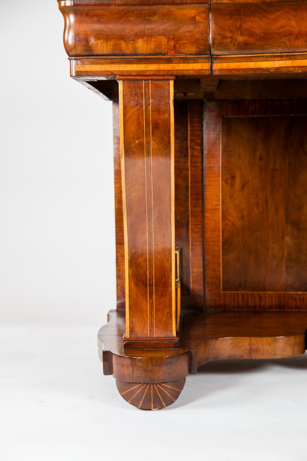 19th century inlaid Biedermeier console table, the cross banded top with inlaid quarter fans in each corner, the OG shaped frieze with central drawer above serpentine shaped inlaid legs supporting lower shaped shelf, inlaid and crossbanded back