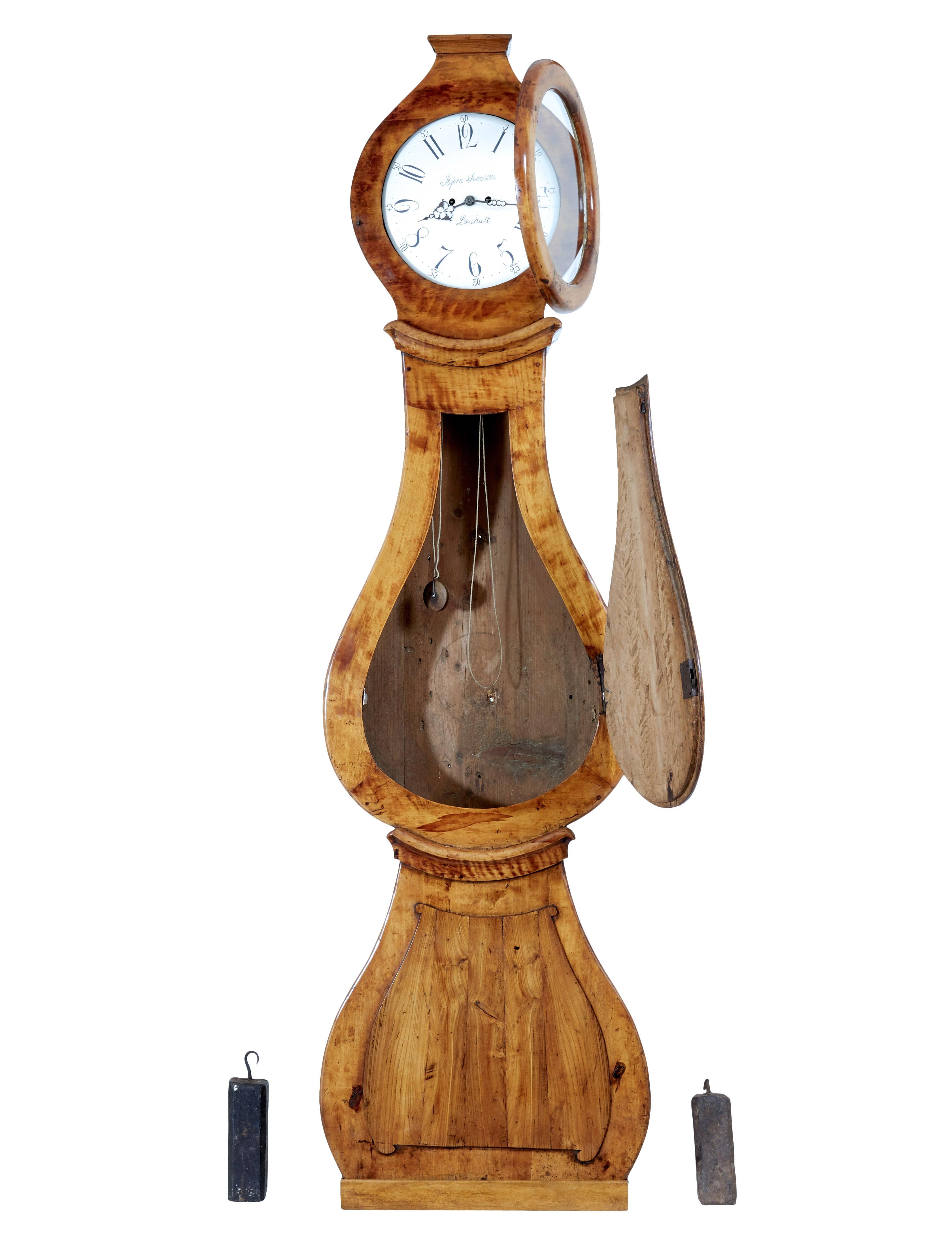 19th century inlaid birch mora long case clock circa 1840.

Elegant mora clock with well balanced proportions, typical banjo shaped clock from the mora region in sweden.

Removable hood with modest cornice top, reveals a white enamelled clock