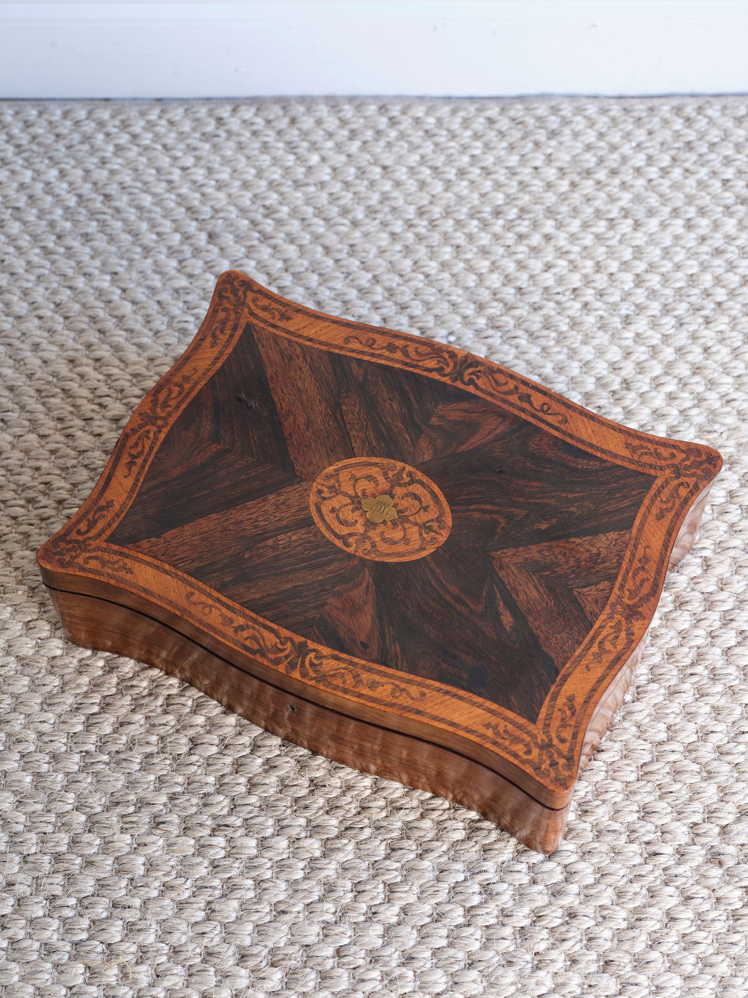 This beautiful hand inlaid box has so many unique details and the high quality workmanship is evident. There are curves along each side of the box that give it a lovely feel.  It has warm patina stain and is structurally sound. Both of the hinges