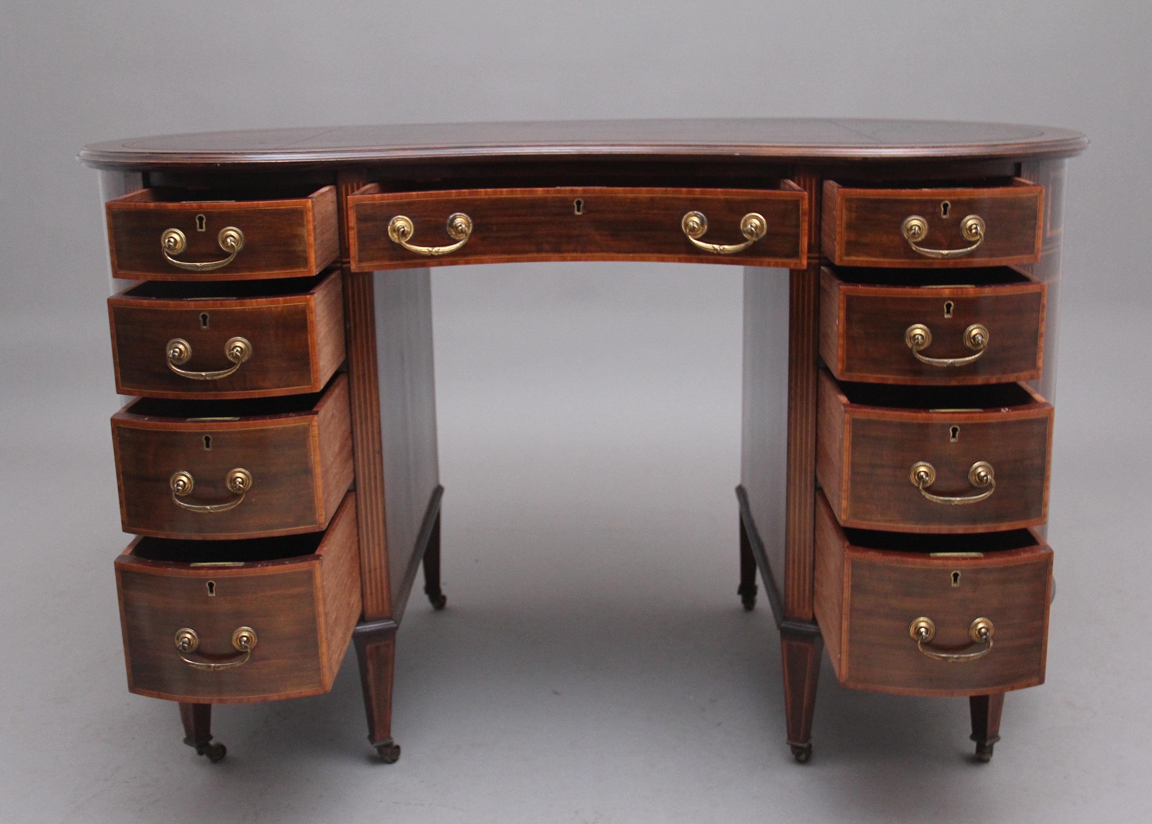 A fine quality 19th Century inlaid mahogany kidney shaped desk with tulipwood, satinwood and boxwood stringing, the shaped and moulded edge top having a tan brown leather writing surface decorated with blind tooling, there is a combination of nice