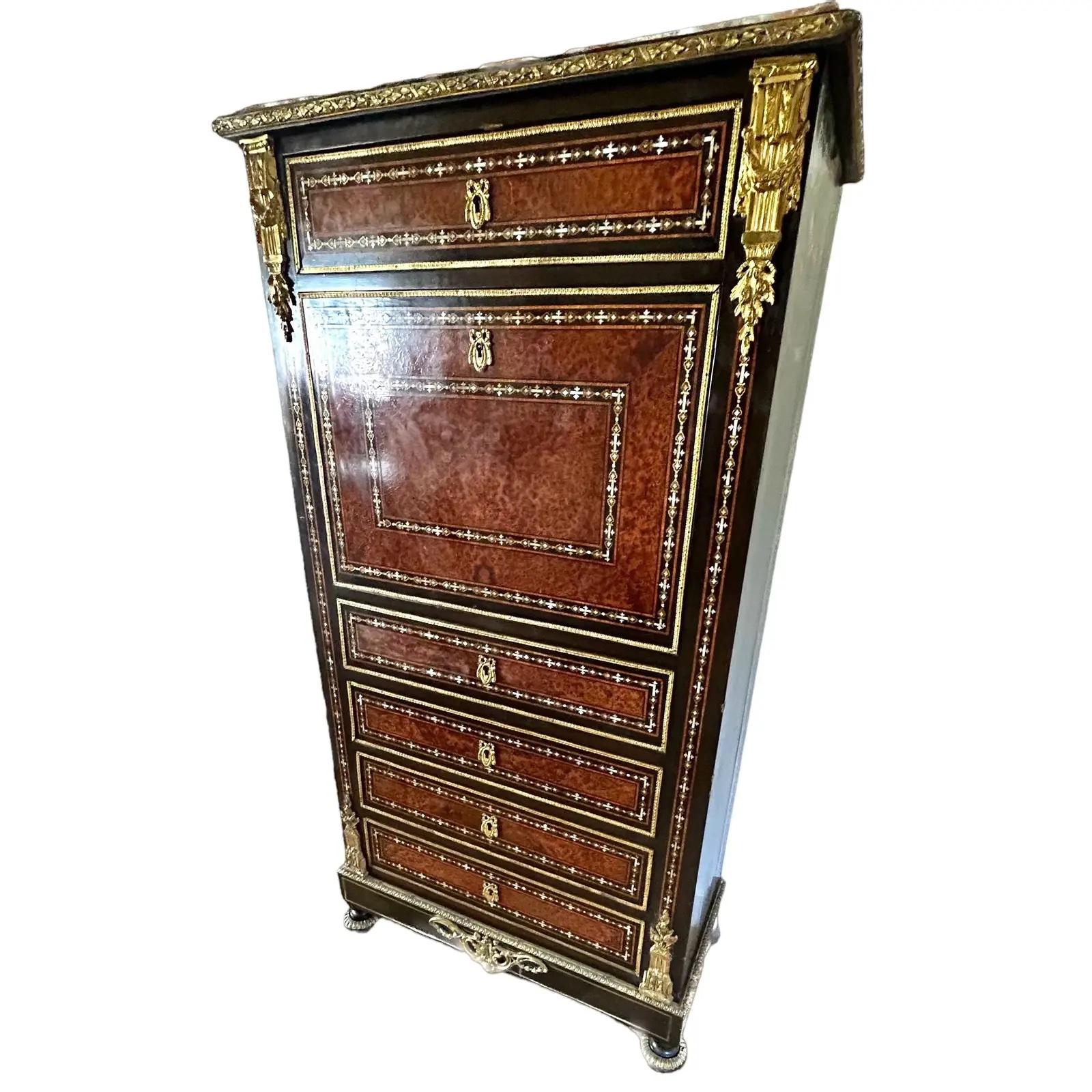 Napoleon Desk/Secretary with gilt bronze molding and inlaid details.. It has a beautiful pink marble top.  Its sides are in blackened pear and its facade in cedar. It has rosewood framing with inlays of mother-of-pearl and brass on ebony