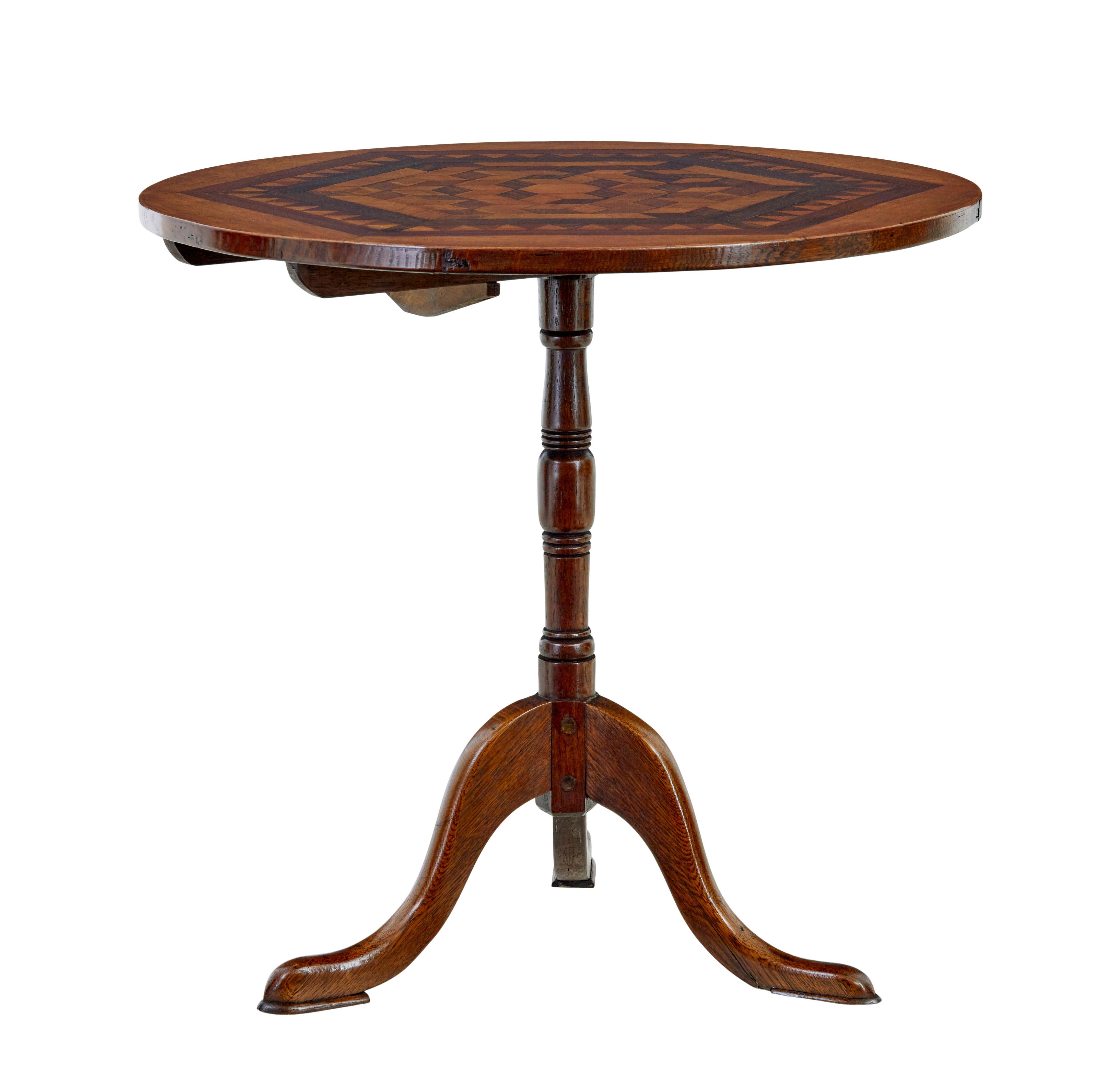 19th century inlaid oak round occasional table circa 1880.

Good quality round tilt top table, ideal for many uses around the home.

Circular top inlaid with a geometric pattern, featuring exotic woods such as walnut and tulp.  Raised on a turned