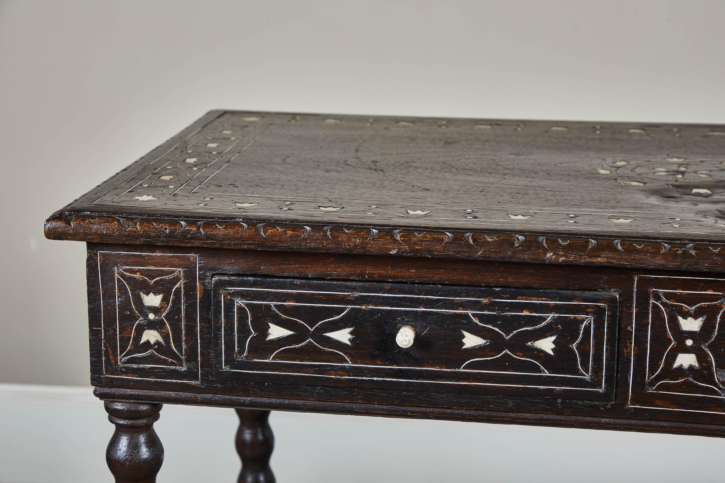A late 19th century Spanish Colonial style console table with two drawers. With later metal and bone inlay. Walnut construction, in good antique condition.