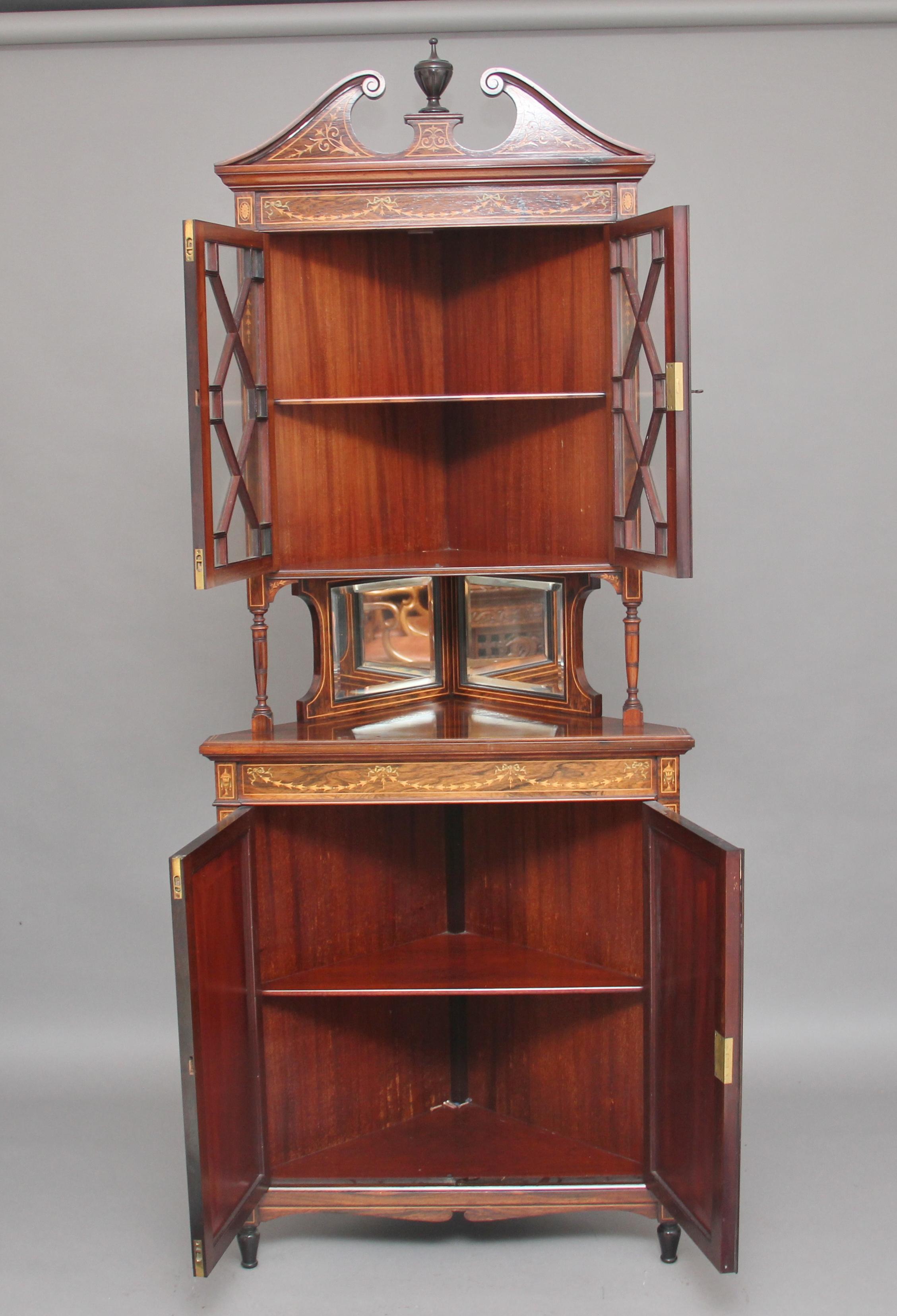 19th century inlaid rosewood corner cabinet by “Edwards & Roberts”, the cabinet is in two pieces, the top piece having an inlaid swan neck pediment with a central turned finial, with two astrigal glazed doors decorated with boxwood lines and floral