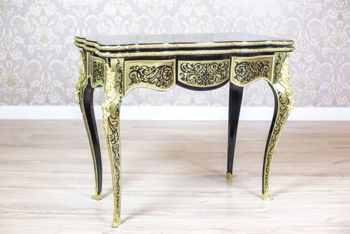 19th Century Inlaid Table in the Boulle Type

We present you a table from the second half of the 19th century in the Boulle type, covered with an elaborate brass inlay that refers to the 16th century Baroque Boulle marquetry.
This wall piece of