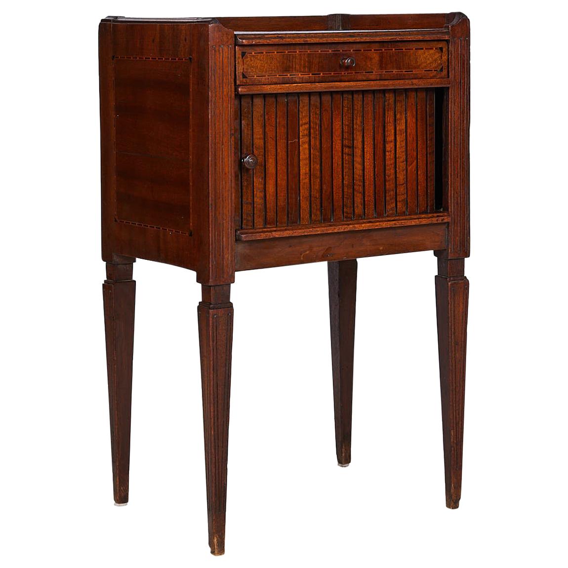19th century neoclassical Italian side table of mahogany, walnut, satinwood, and ebony. The table has a decorative band of inlay inset on the top with a gallery surrounding it on three sides. The case, with inlay on either side, holds an inlaid