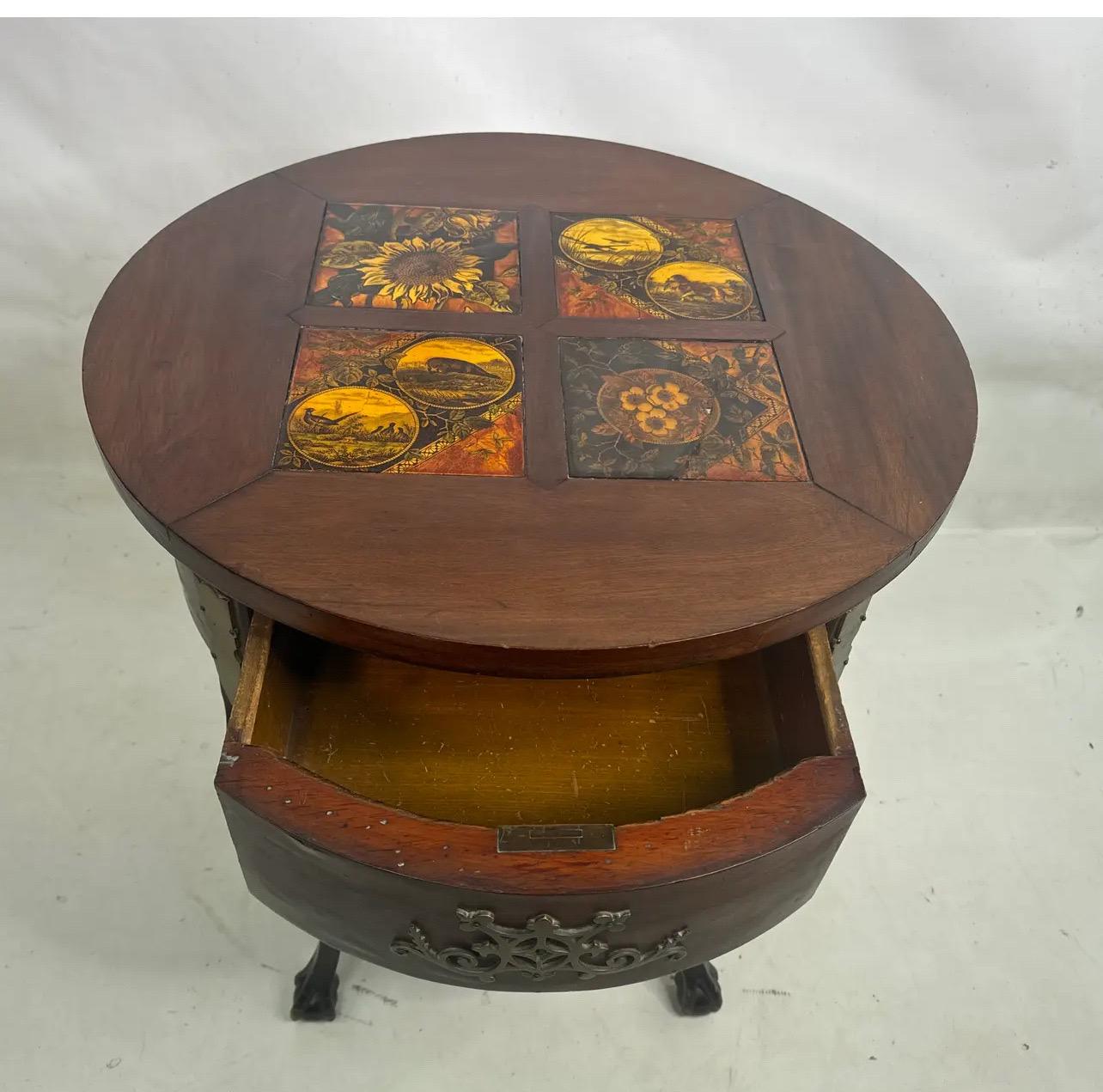 Great 19th century table with four detailed scened  tiles set in the top with heavy adorned brass on the outside and on drawer..Tiered shelves and curved legs with Eagle engraved feet .Hand cut dovetailed construction and a true treasure from that