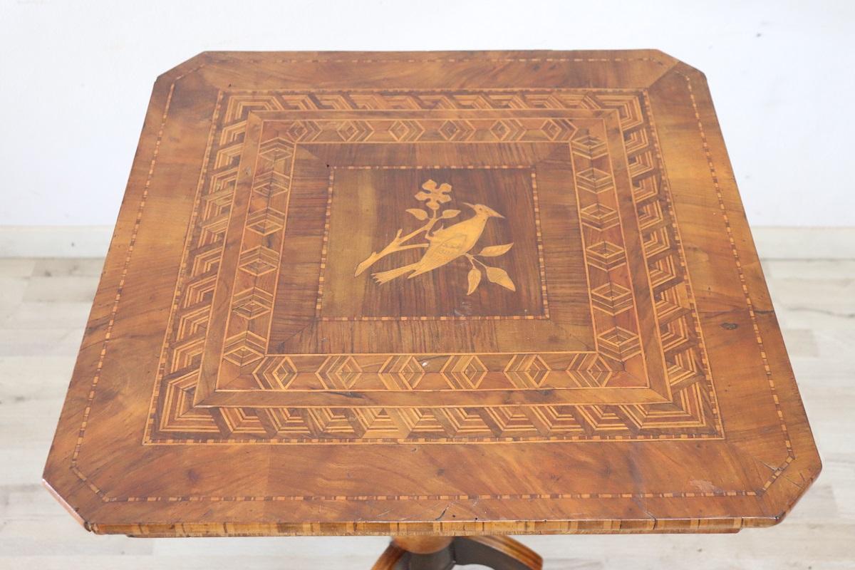 Rare and fine quality Italian antique tripod table or pedestal table.  The table is made up of a square top supported by a central turned pedestal and three feet. Characterized by a refined inlay decoration made with small pieces of various precious