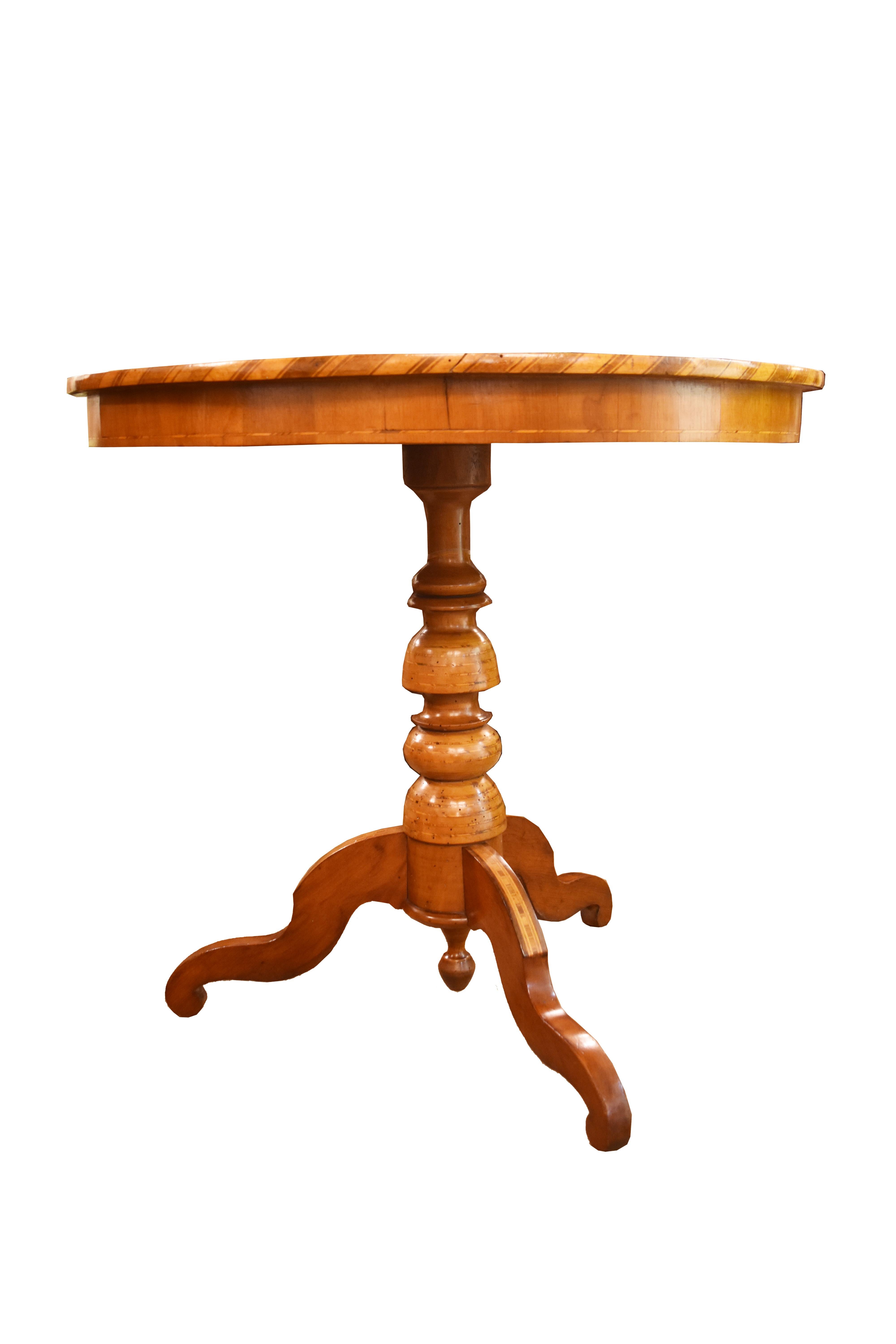 This Italian walnut pedestal table features intricate inlay with geometric parquetry. The inlay continues on the tripod base.