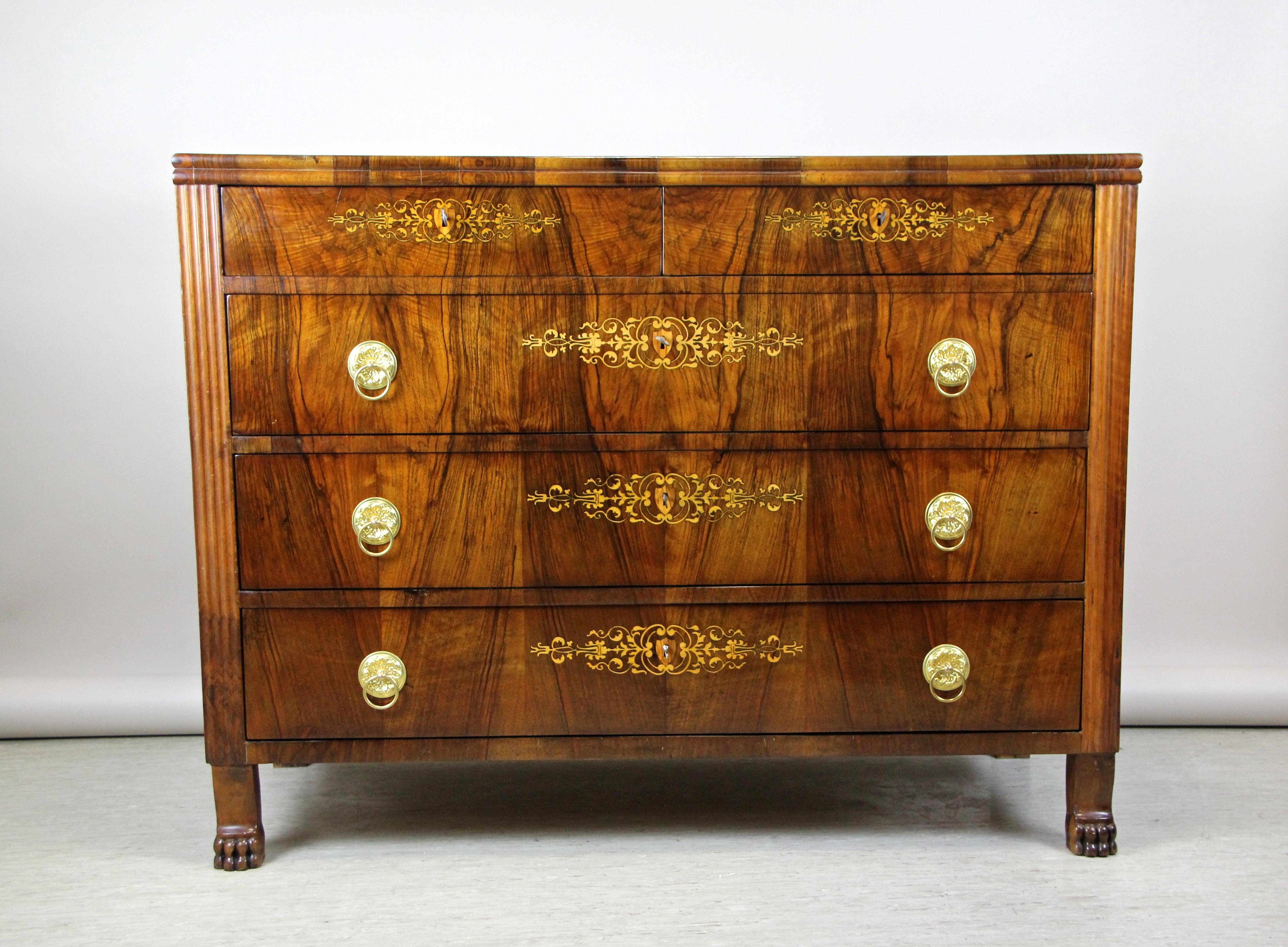 Dreamlike early 19th century chest of drawers from the famous Biedermeier era in Hungary circa 1830. A real majestic commode impressing with straight lines and eye-catching inlay works on the front of the drawers. Also the great bookmatched walnut