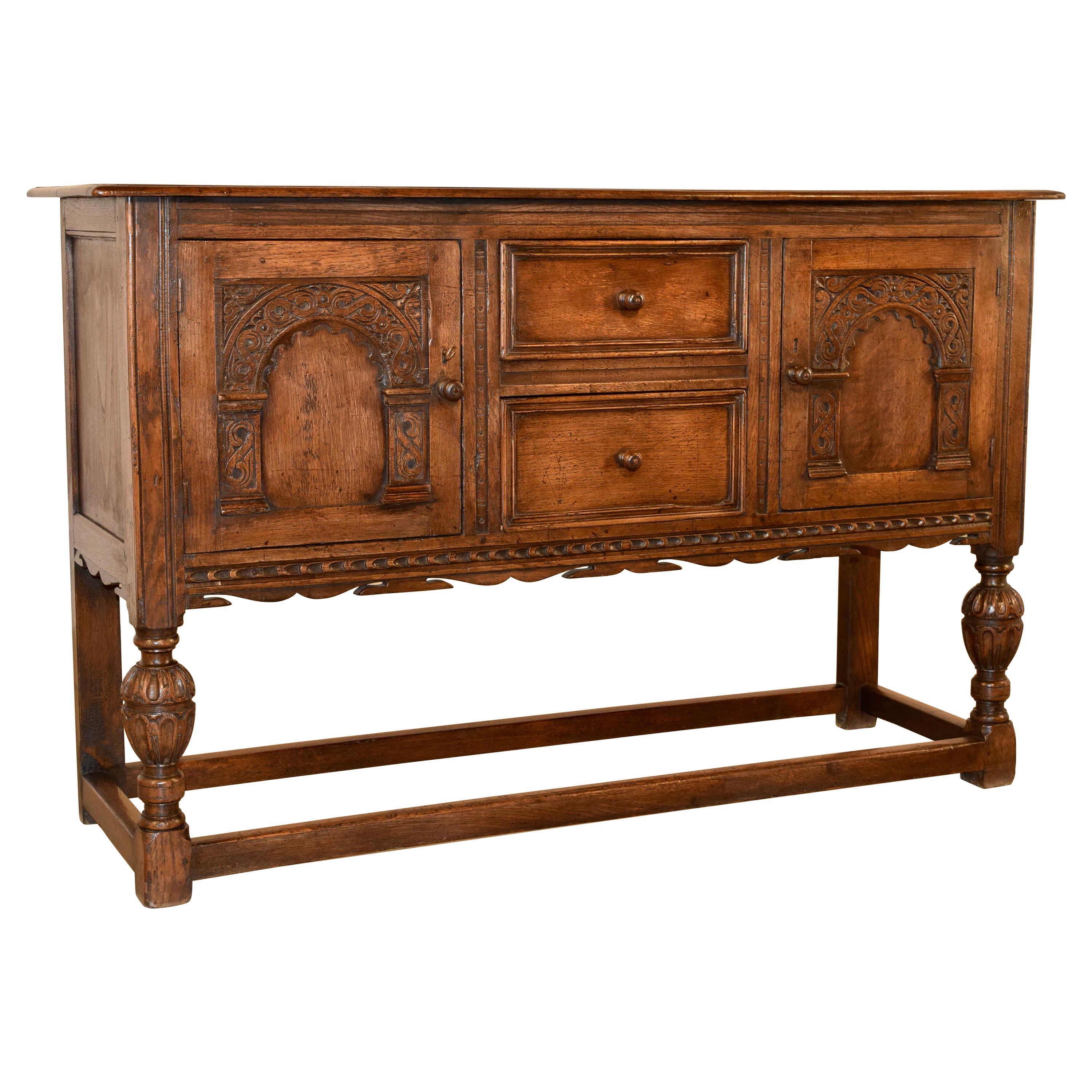 A gutsy Jacobean revival carved oak server table from England c.1840 at