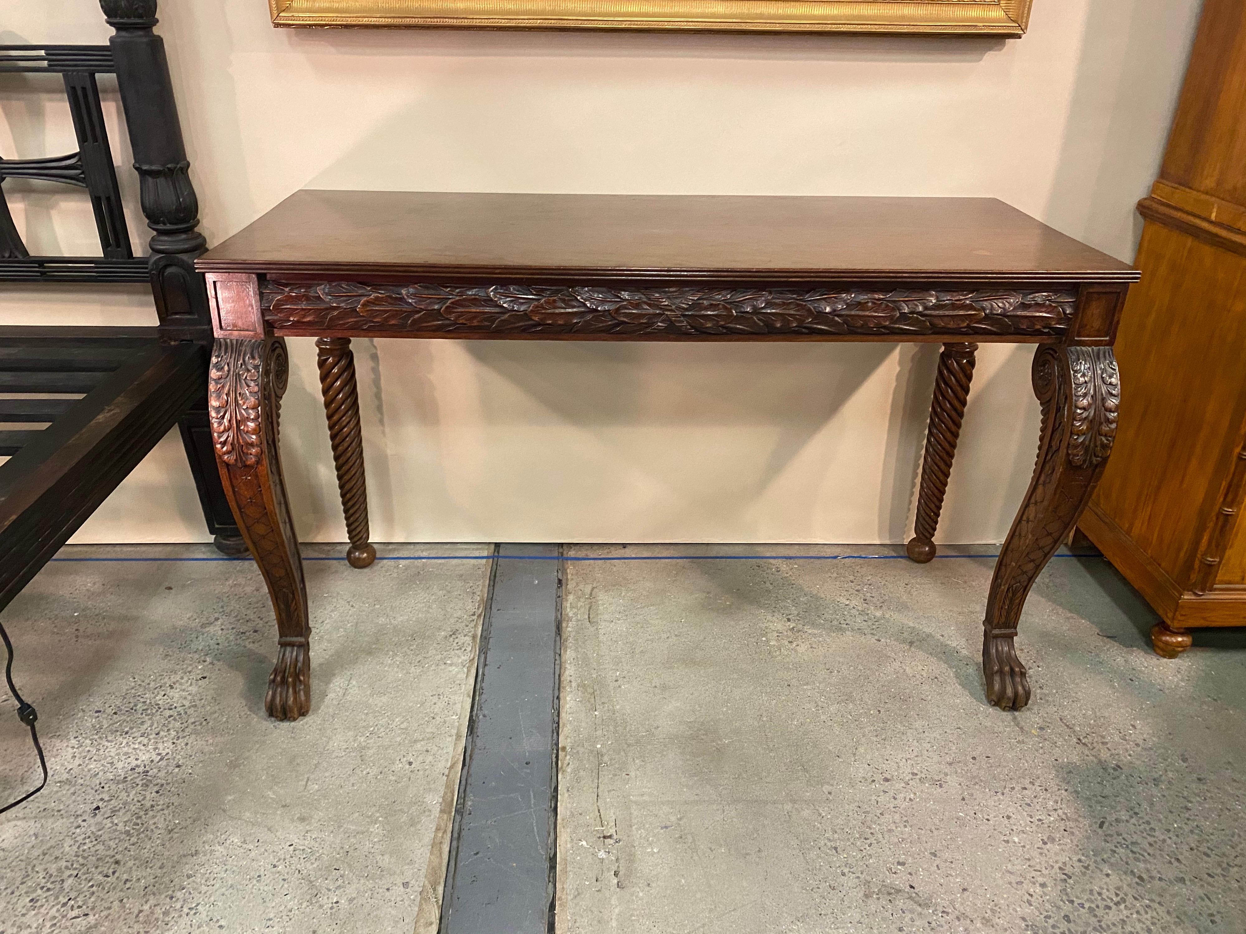 Great 19th century Irish carved mahogany console with oak leaves and paw feet. Highly carved legs and apron.