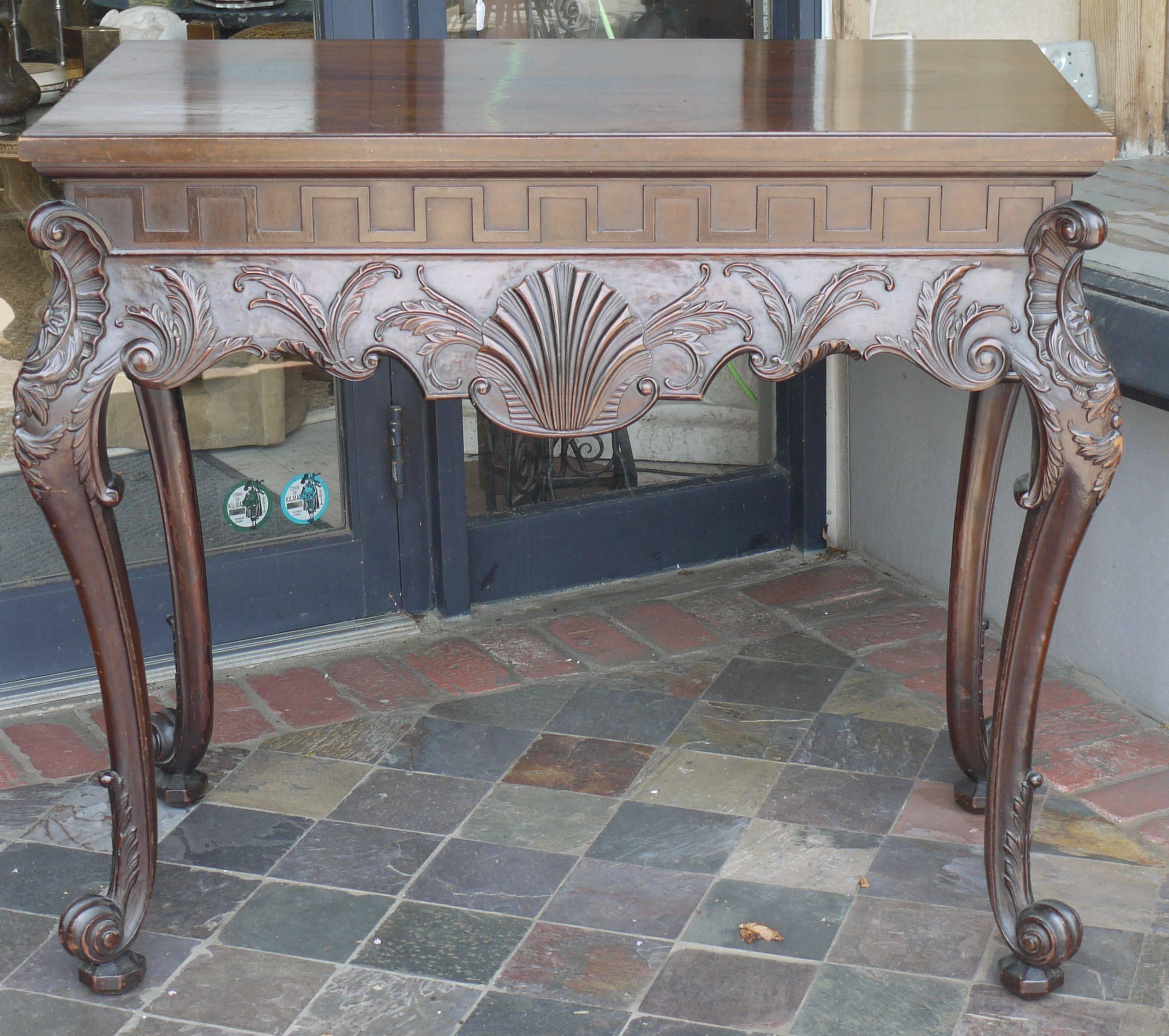 Incredible carving on this 19th century Irish Chippendale console. Great lines, finished on back, top is appropriately bleached out. Light craquelure to finish on top.