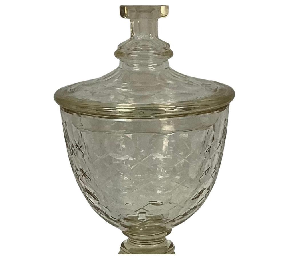 Tall Irish Glass compote with lid. Raised on a curved stemmed base with a goblet-style body featuring beautiful cut glass with matching lid. Excellent condition, no chips or cracks.