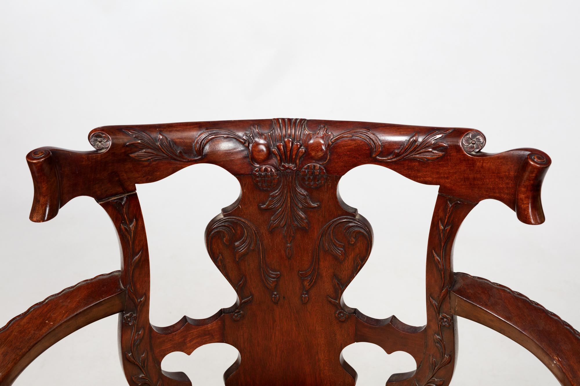 Offener Sessel aus irischem Mahagoni des 19. Jahrhunderts. Dieser Schreibtischstuhl im georgianischen Stil mit massivem, geschnitztem Sims und oberer Schiene, ausgebreiteten Armlehnen, ovaler Sitzfläche und Sitzschiene mit Jakobsmuschel, steht auf