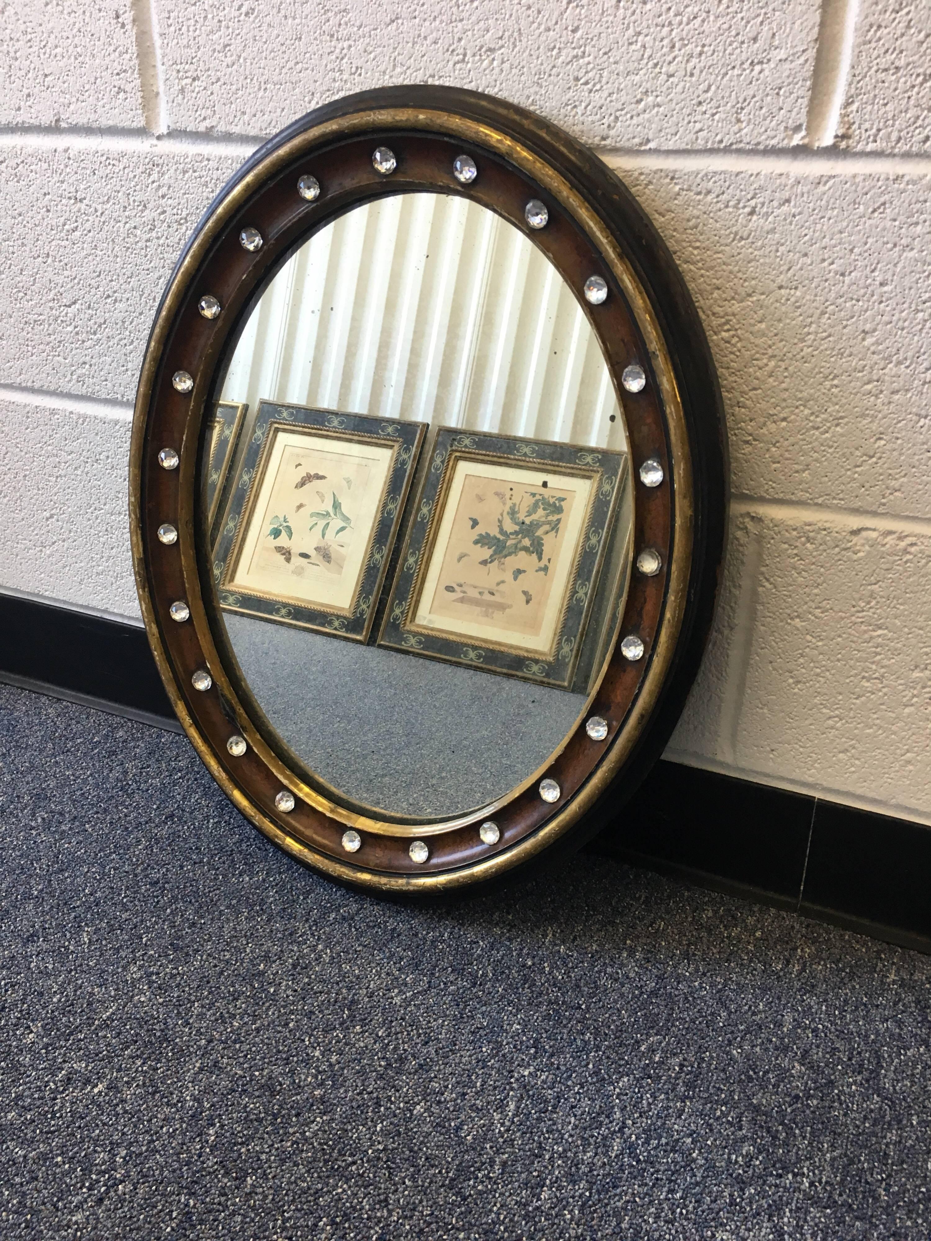 19th century Irish Regency mahogany oval mirror. Rare brown mahogany with faceted glass studs, circa 1840. 

Provenance: Private Estate, Southampton, NY
Harley Antiques, Wiltshire, England, UK.