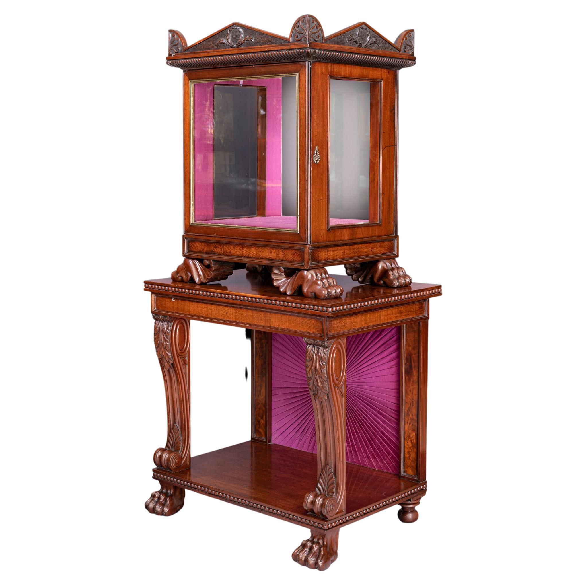 A very fine and most unusual Irish Regency mahogany display cabinet by Gillington`s of Dublin. The architectural shaped top above a glazed door for displaying purposes resting on four carved paw feet above a console style base with cabriole legs