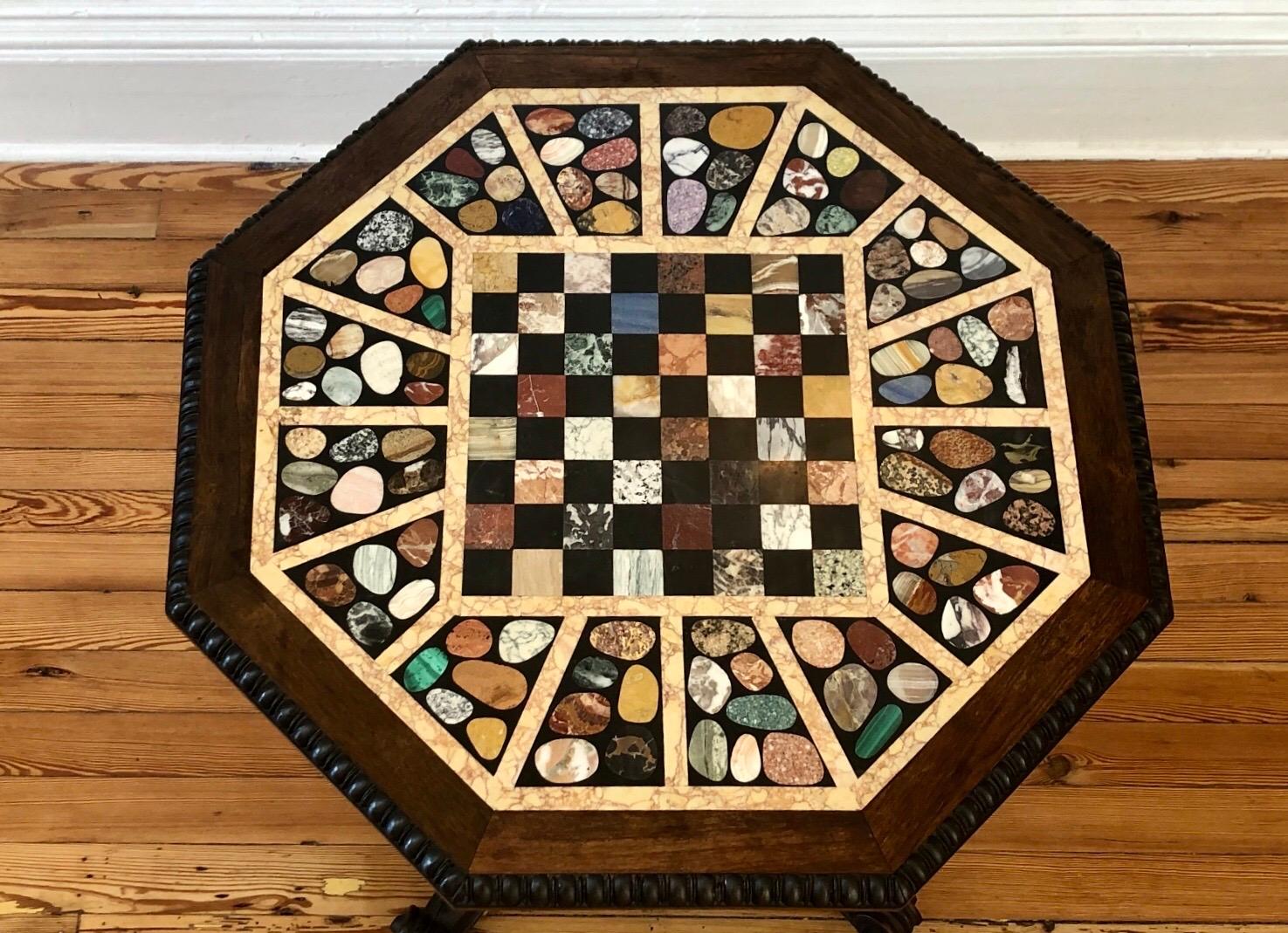 This extraordinary octagonal center table has a specimen marble chess table-top with Pietra Dura semi-precious stones. The late Regency specimen marble is inset into a rosewood frame with egg and dart molding setting on acanthus carved columnar